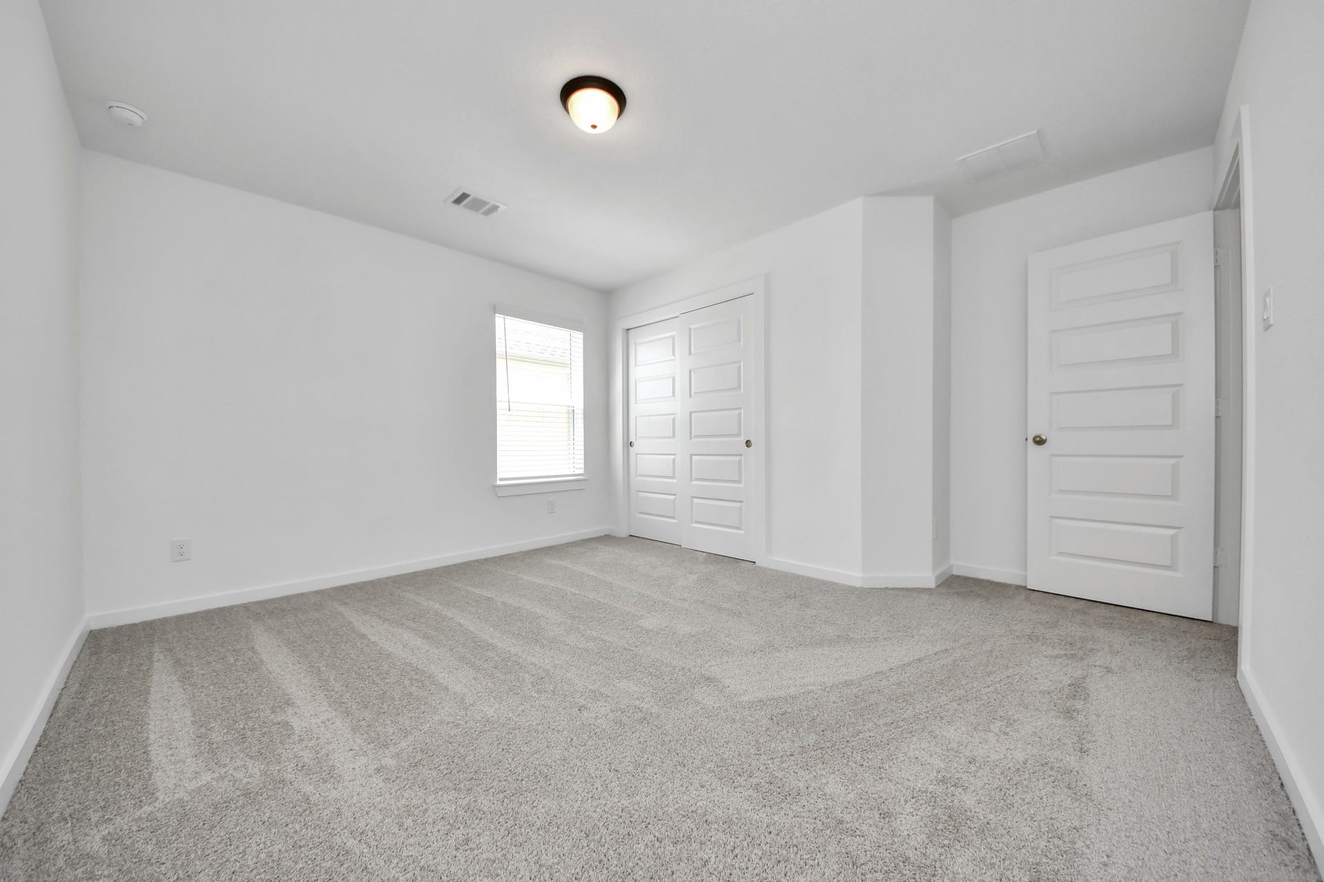 Generously sized secondary bedrooms featuring spacious closets, soft and inviting carpeting underfoot, large windows allowing plenty of natural light, and the added touch of privacy blinds for your personal retreat. Sample photo of completed home with similar floor plan. Actual colors and selections may vary.
