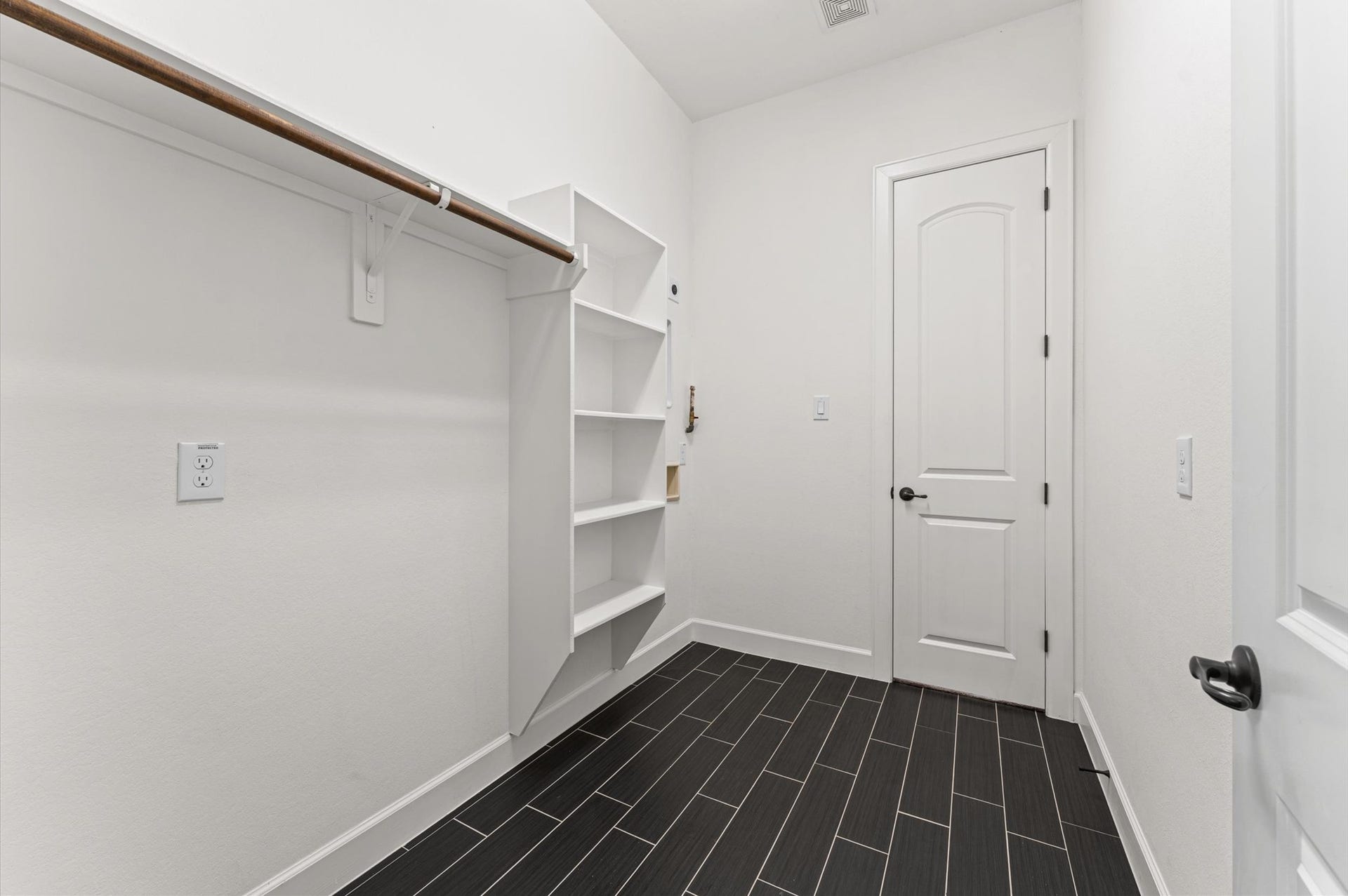 Conveniently located near the primary bedroom, the utility room offers easy access and added functionality, making everyday laundry tasks a breeze
