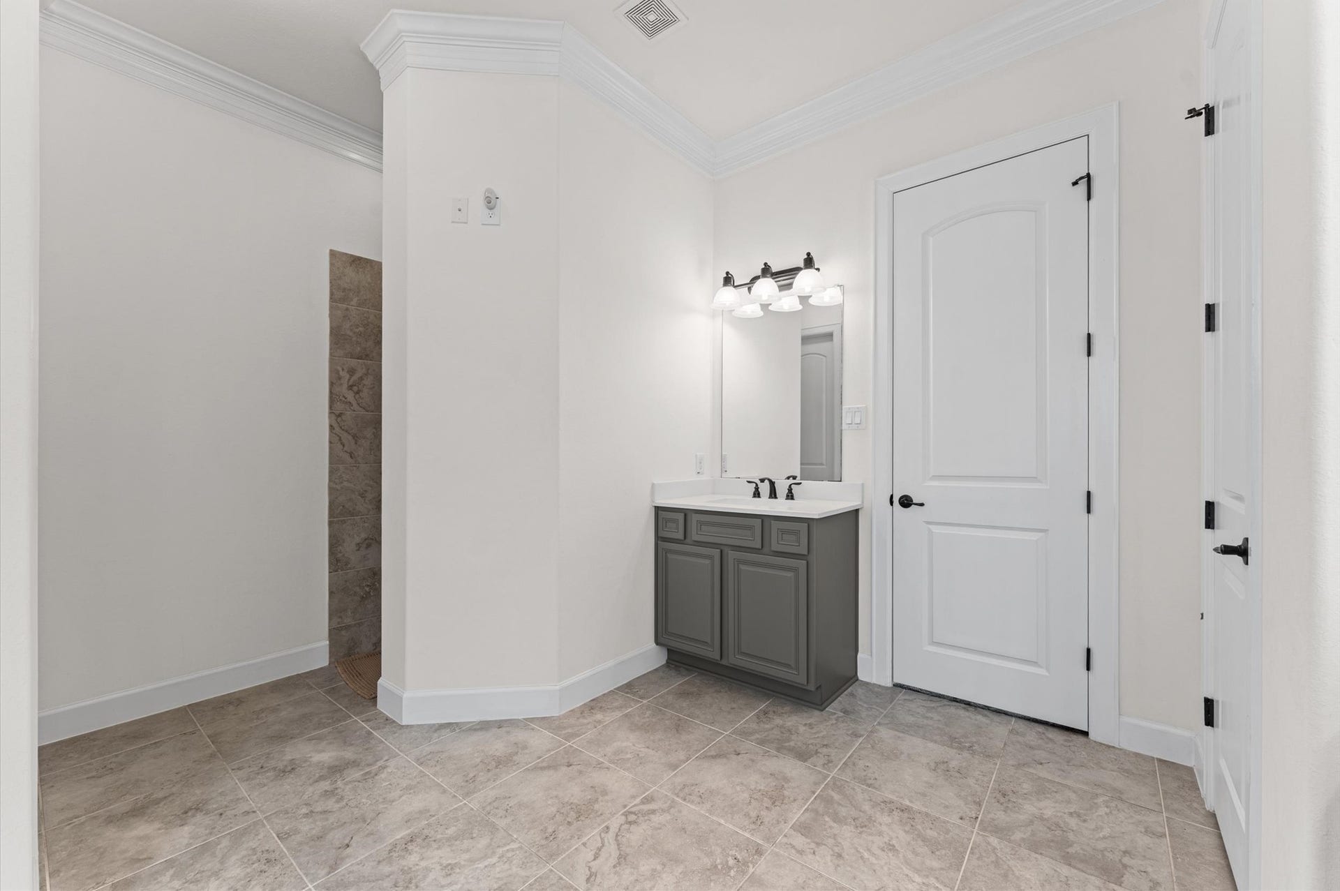 The second vanity area in the primary bathroom offers added privacy and a separate walk-in shower completes this thoughtfully designed space, blending comfort, functionality, and timeless elegance