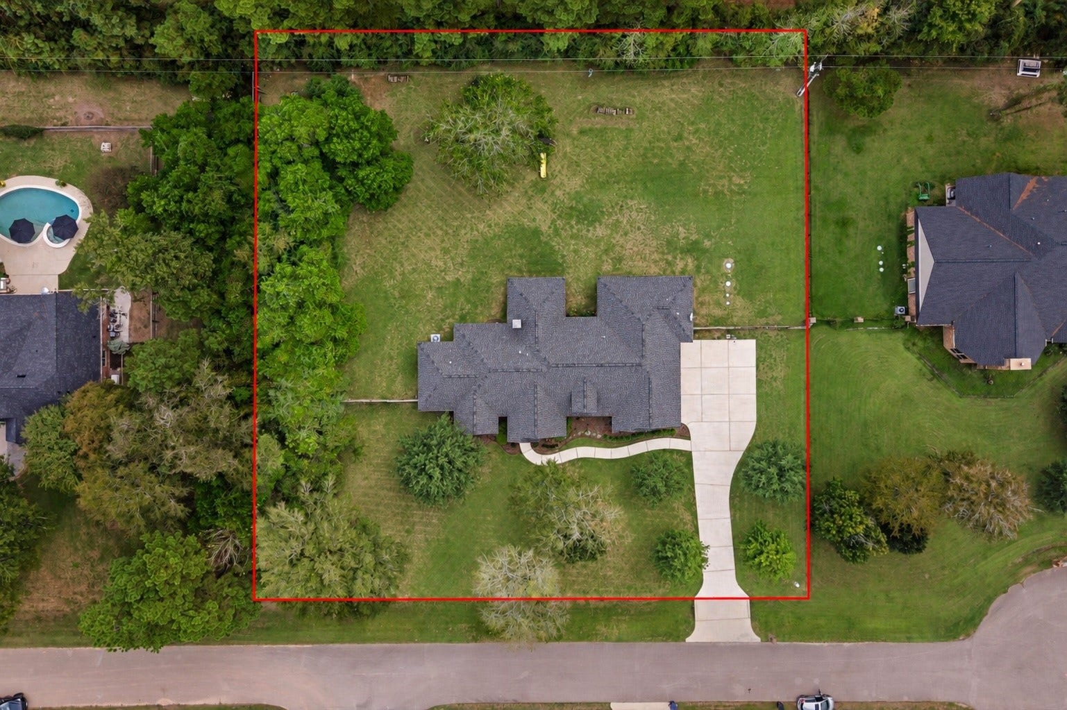 A stunning aerial view showcases this expansive one-acre property, featuring a spacious driveway, three-car garage, and exceptional backyard privacy with no rear neighbors! Enjoy the best of both worlds; convenient access to city amenities while escaping to the peace and tranquility of your own private retreat.