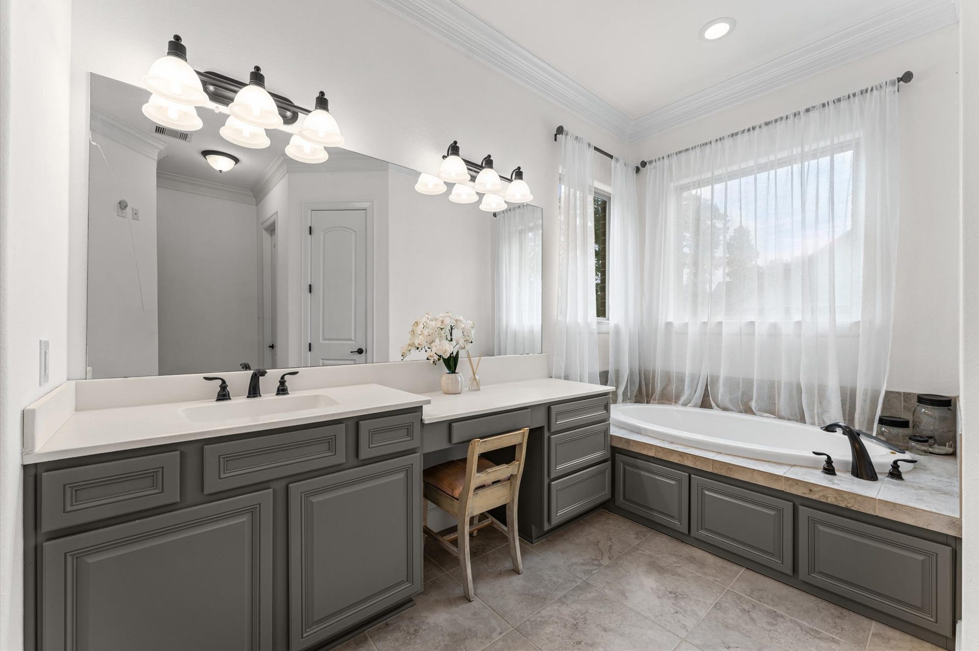 The spacious primary bathroom features two separate vanity areas, providing ample countertop space and storage for added comfort and convenience. A separate soaking tub completes this beautifully designed retreat, offering the perfect place to relax and unwind!