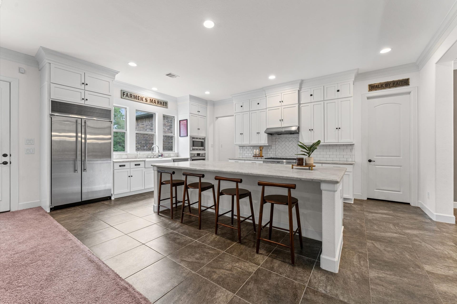 Oversized kitchen island with generous overhang, providing ample space for comfortable seating with barstools or full-sized chairs; perfect for casual dining, entertaining, and everyday gathering
