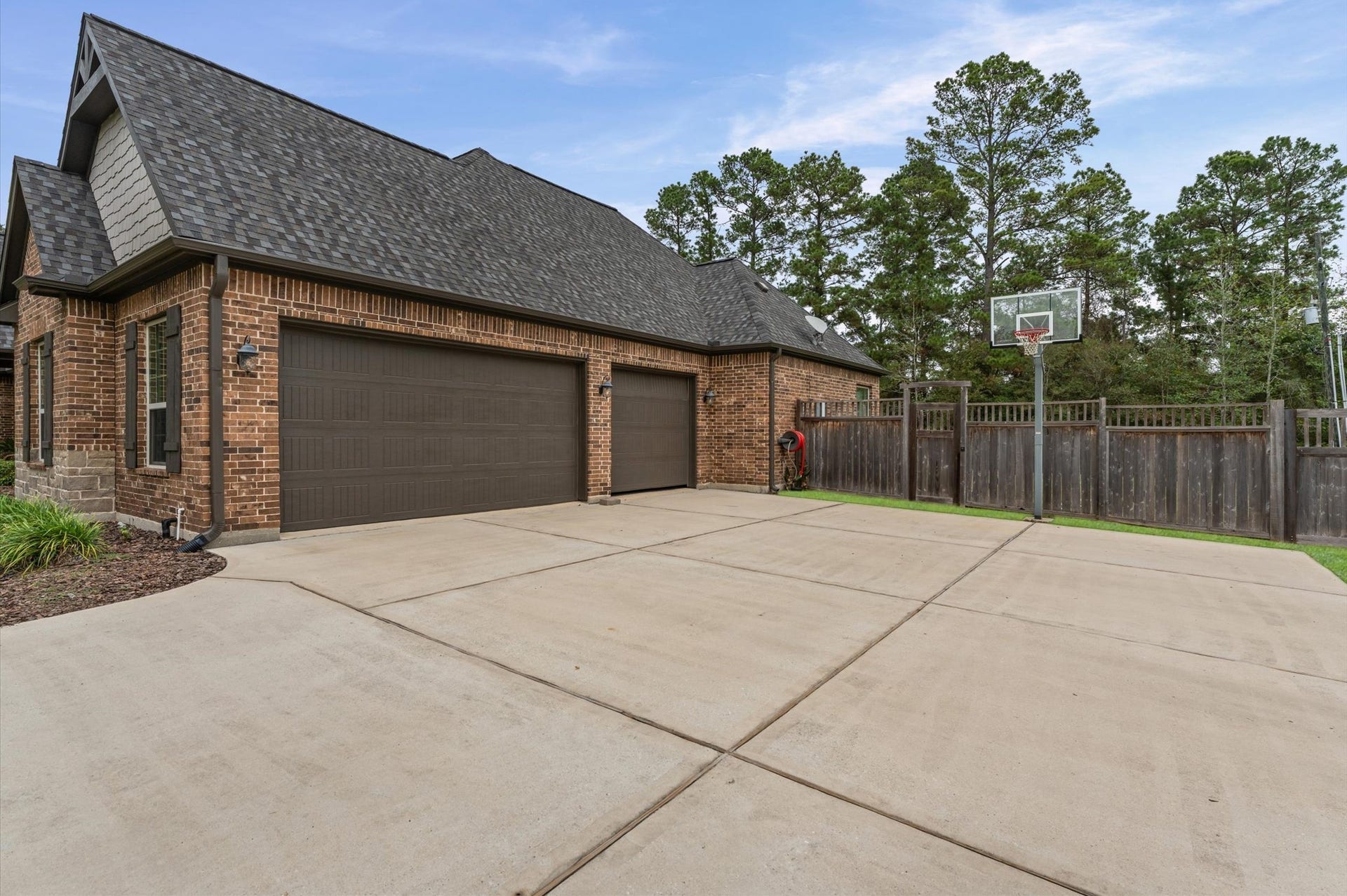 An oversized driveway and THREE-CAR GARAGE provide exceptional space for parking, additional storage, and accommodating guests