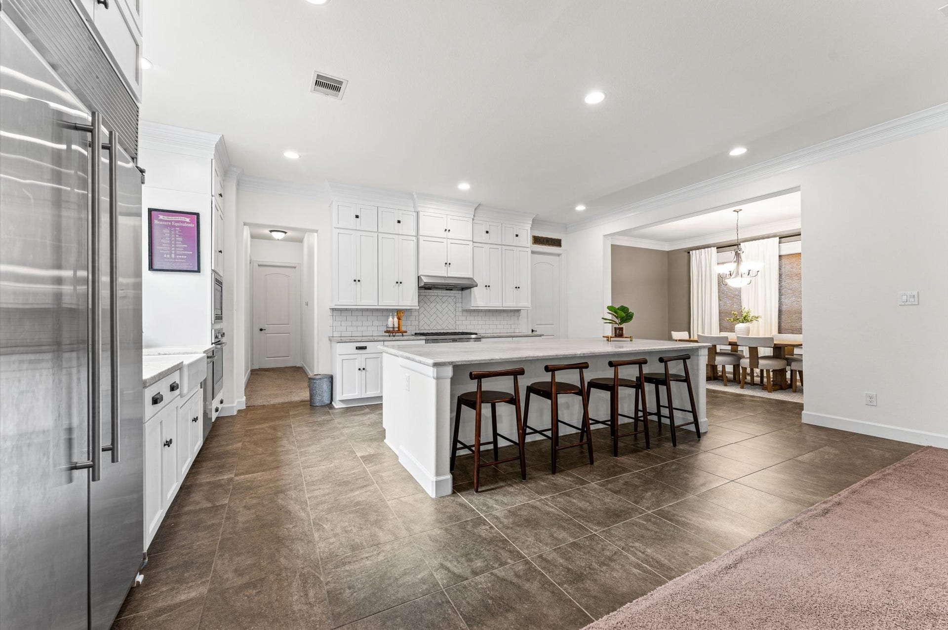 Recessed lighting and an abundance of natural light illuminate the home, creating a bright, warm, and inviting atmosphere throughout!
