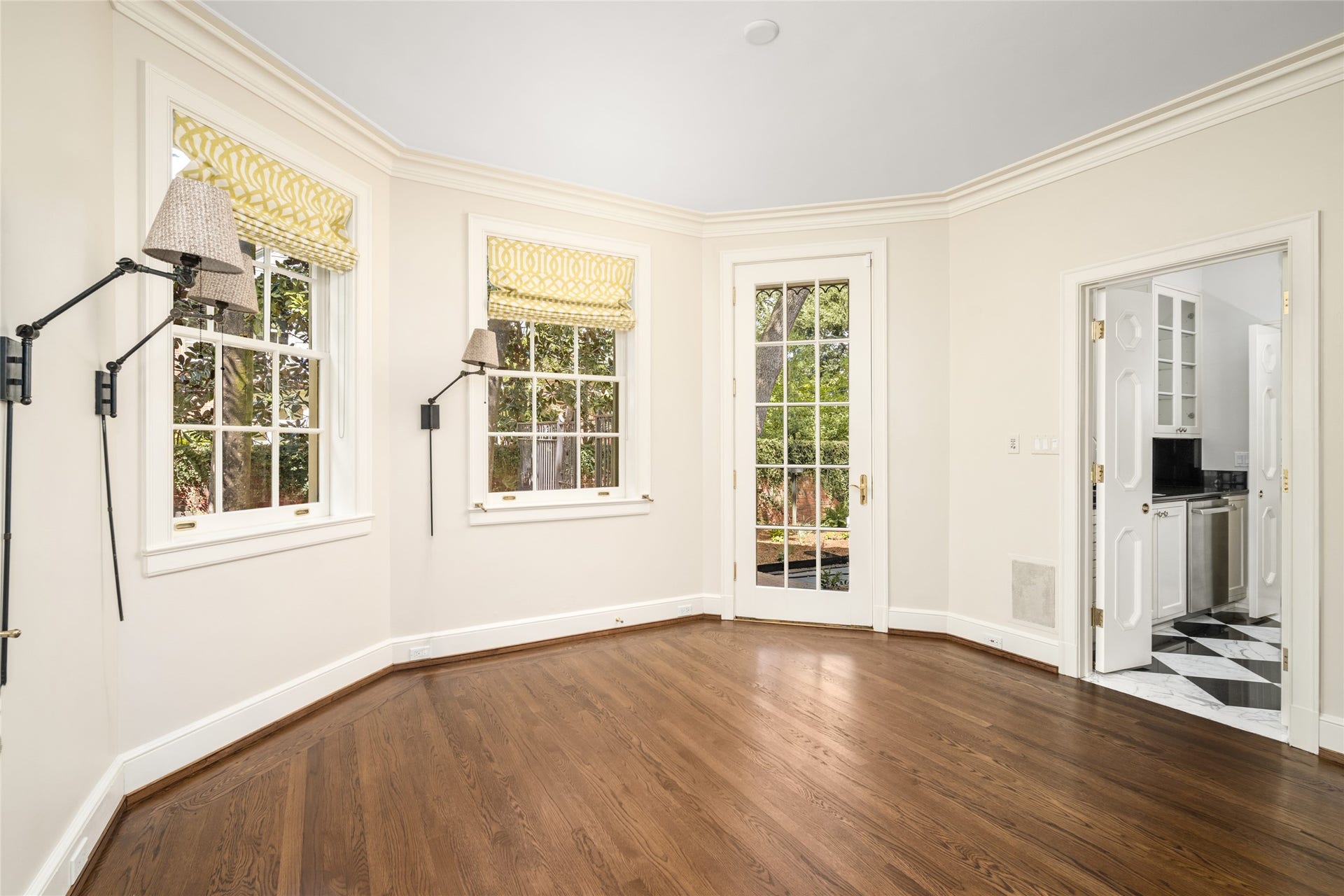 Bright breakfast room next to the side yard and entering into the butlers pantry.
