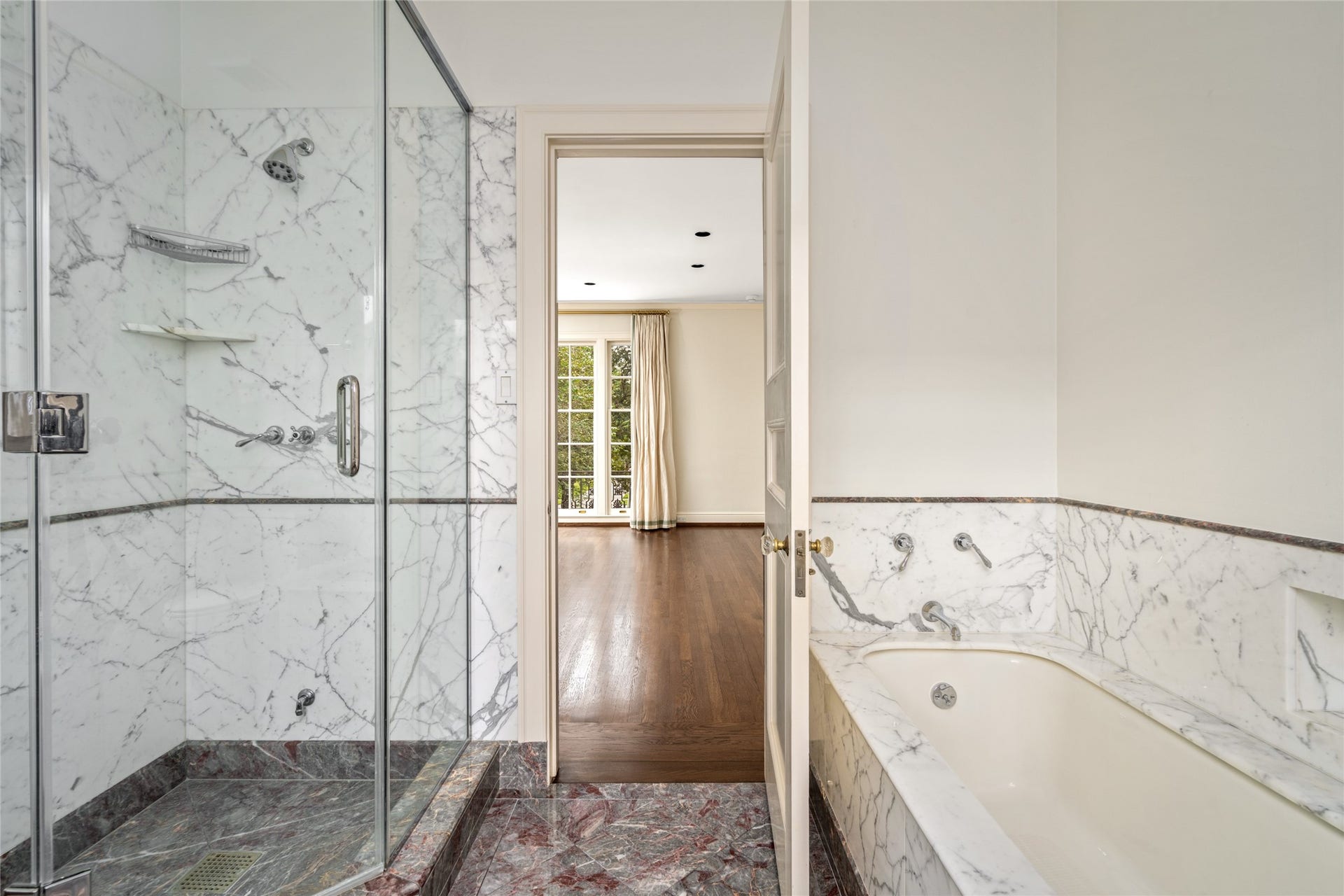 Beautiful bathroom with marble shower and tub.
