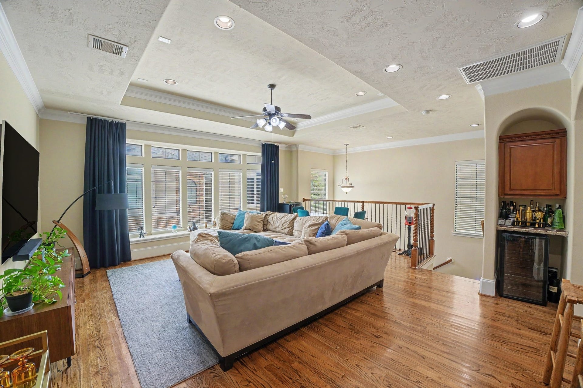 Second floor living with tall ceilings, recessed lighting and gleaming hardwood flooring. Wall of windows make it light and bright