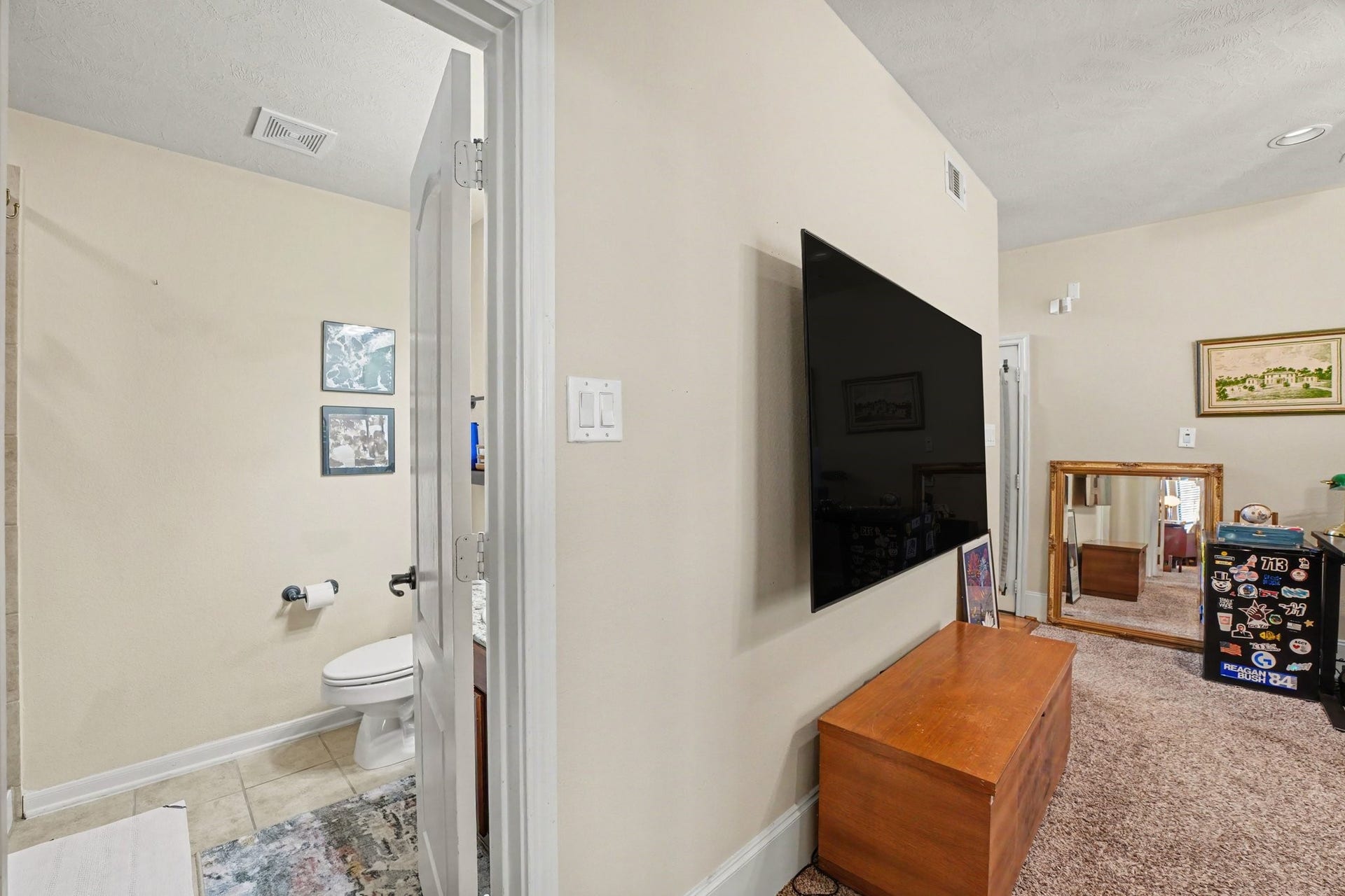 view from bedroom into living space and bath