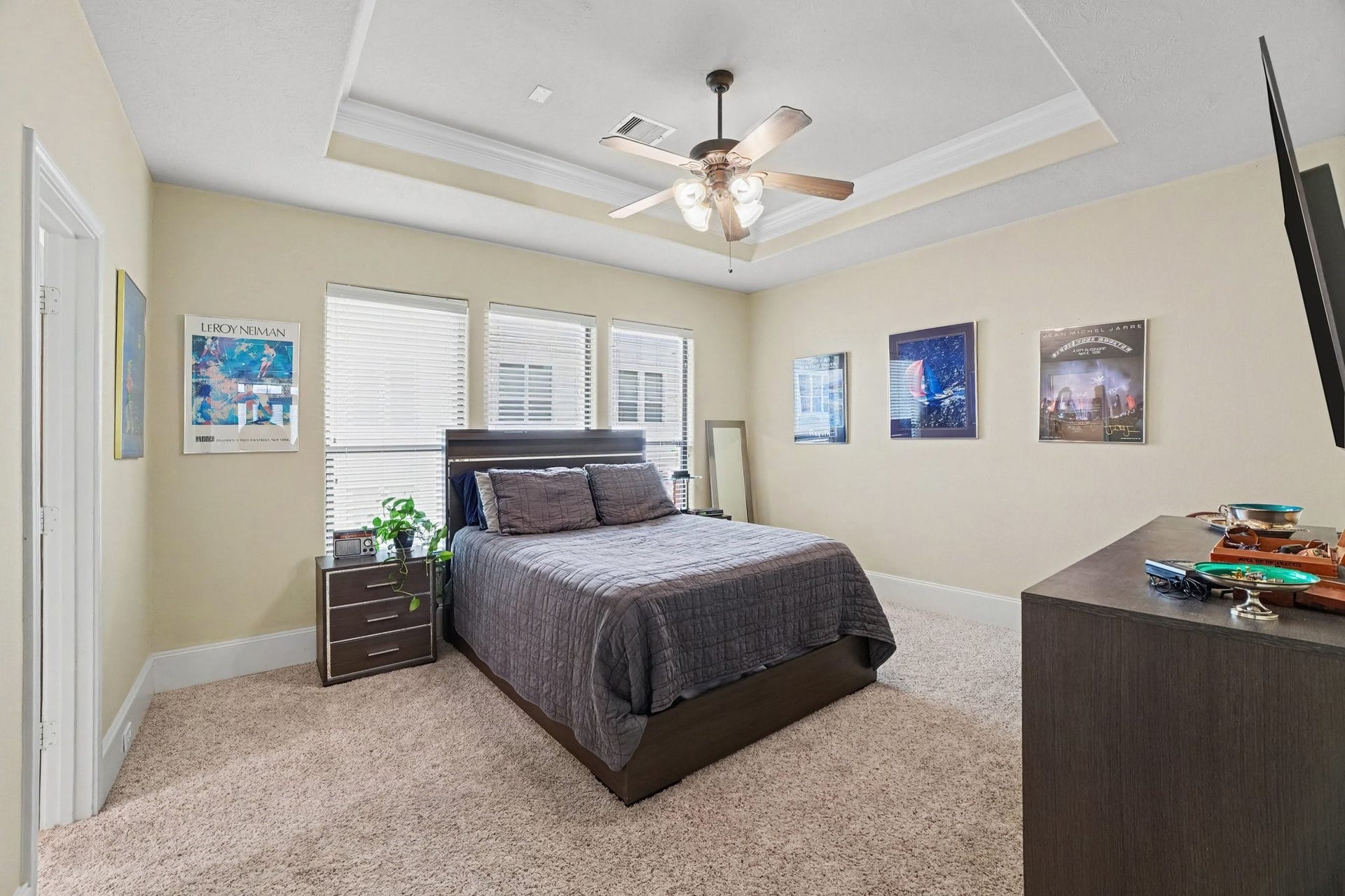 Large windows for natural light, coffered ceiling with fan. Step onto carpet when you get out of bed
