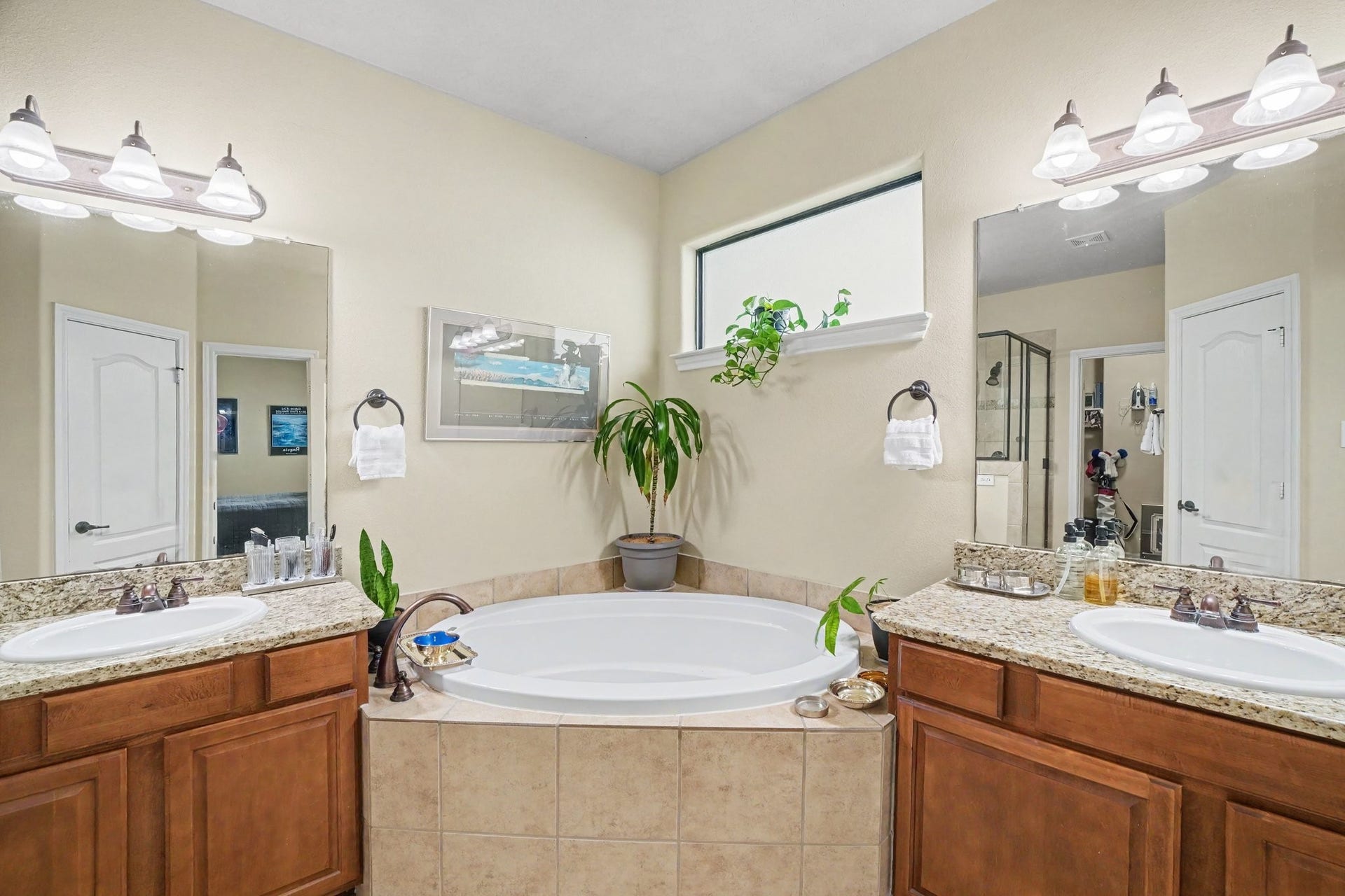 Primary bath has granite counters, two sinks, deep soaking tub