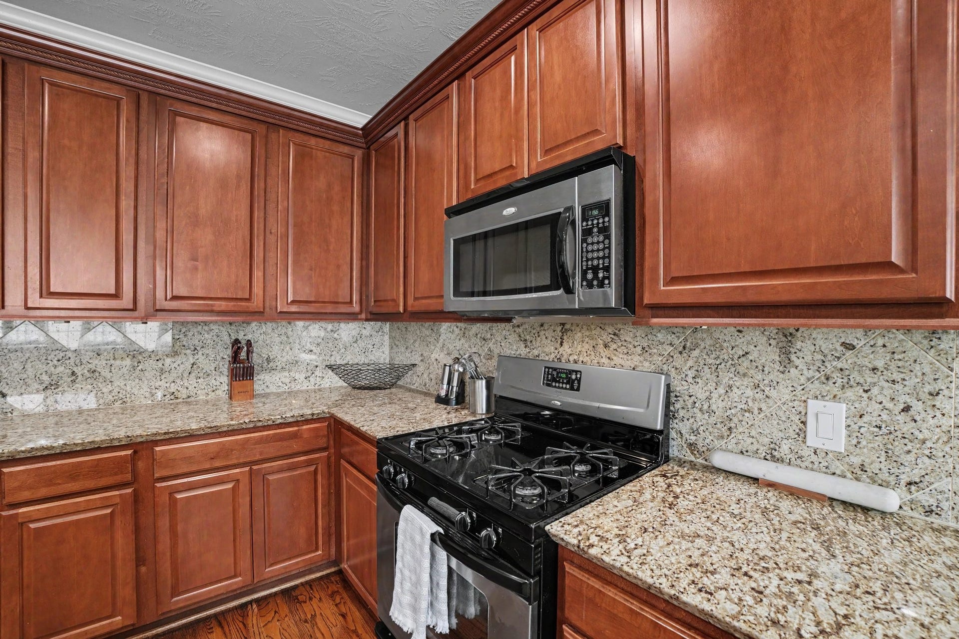 Kitchen has granite countertops, stainless appliances and plenty of cabinets. Built in microwave and gas cooking.