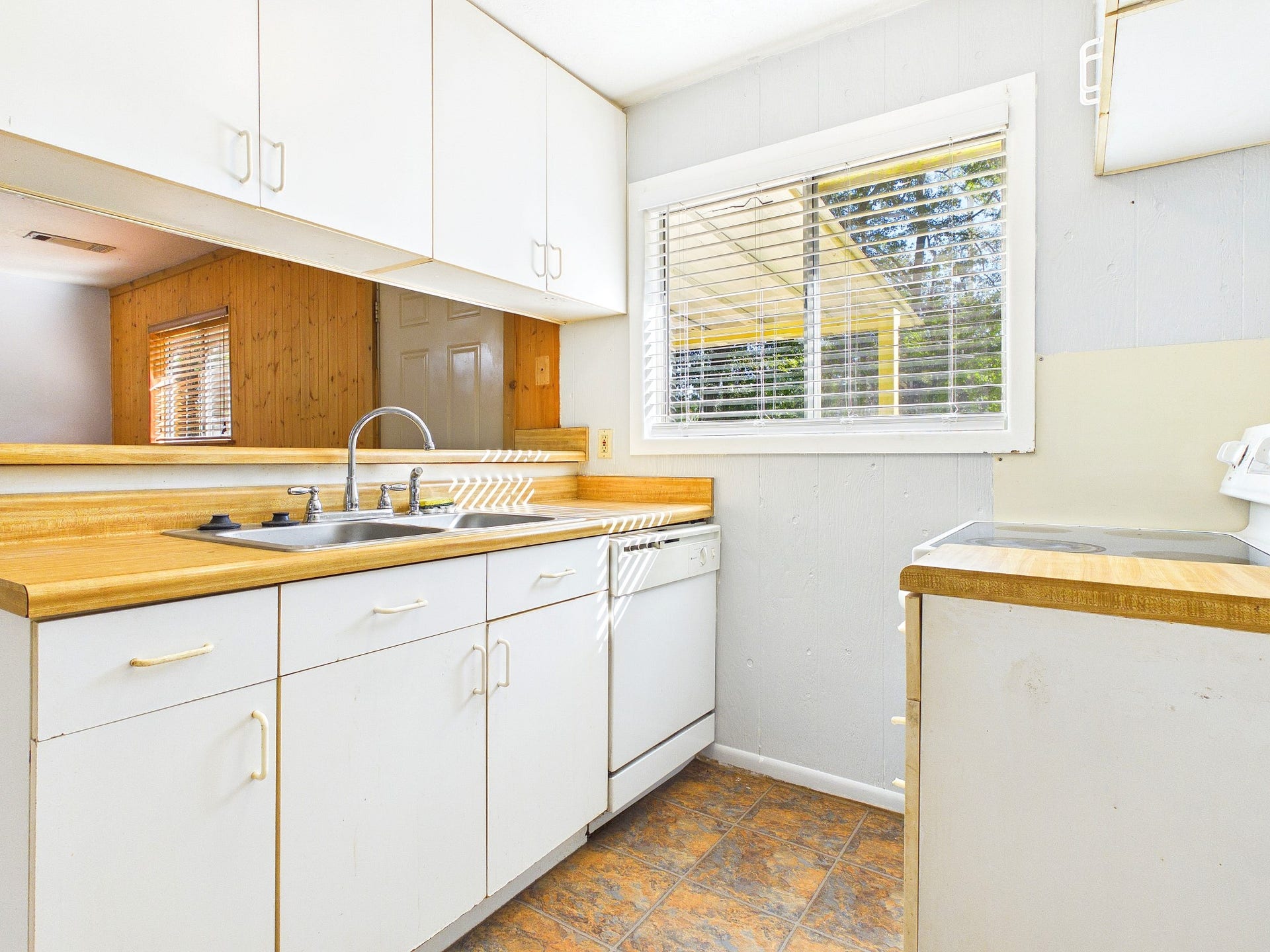 22054 Spears Road, Porter, TX 77365 Charming kitchen featuring bright natural light, ample cabinetry, and a cozy open layout with a functional double sink and dishwasher.