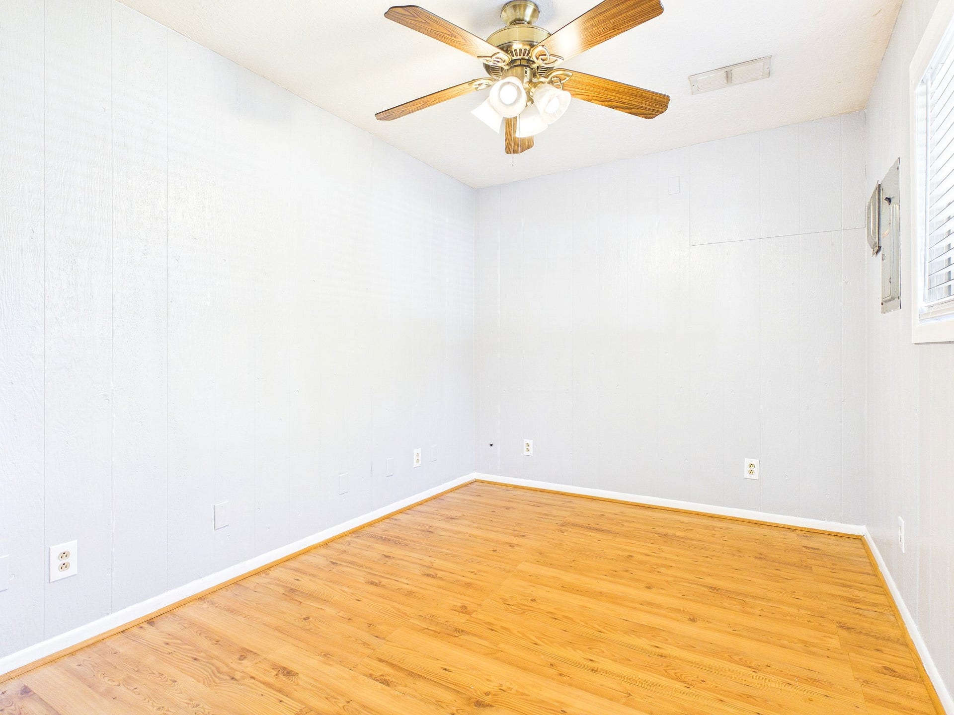 22054 Spears Road, Porter, TX 77365 Bright and inviting room with warm floors and a classic ceiling fan, perfect for a cozy retreat or versatile living space.