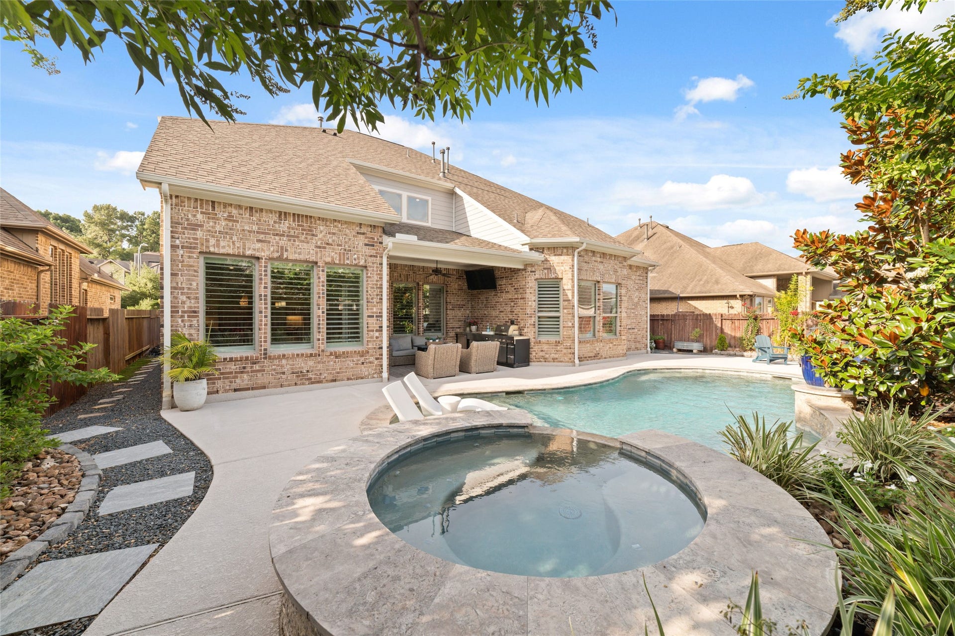 13411 Alpine Mountain Lane, Tomball, TX 77377 View of the rear of the home and large covered patio.