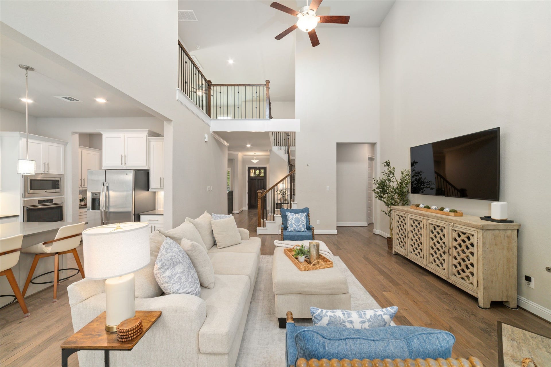 13411 Alpine Mountain Lane, Tomball, TX 77377 Two story ceilings and the upstairs balcony add to the bright open living room at the heart of the home.