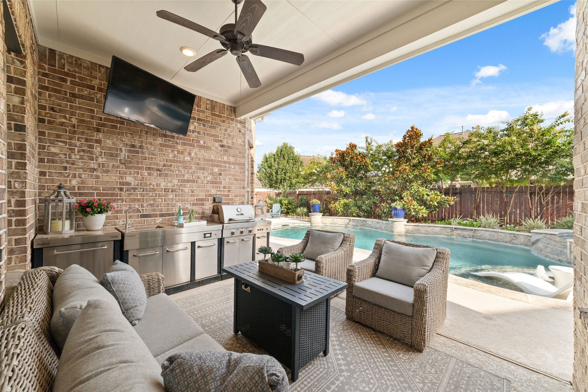 13411 Alpine Mountain Lane, Tomball, TX 77377 The covered outdoor patio, complete with a well-appointed outdoor kitchen, offers the perfect setting for grilling, dining, relaxing, and entertaining while enjoying beautiful poolside views.
