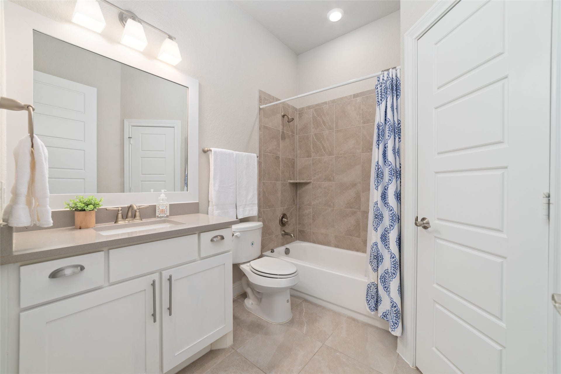 13411 Alpine Mountain Lane, Tomball, TX 77377 The beautifully designed ensuite bathroom boasts boasts finishes, a spacious vanity, and a seamless blend of luxury and everyday functionality.