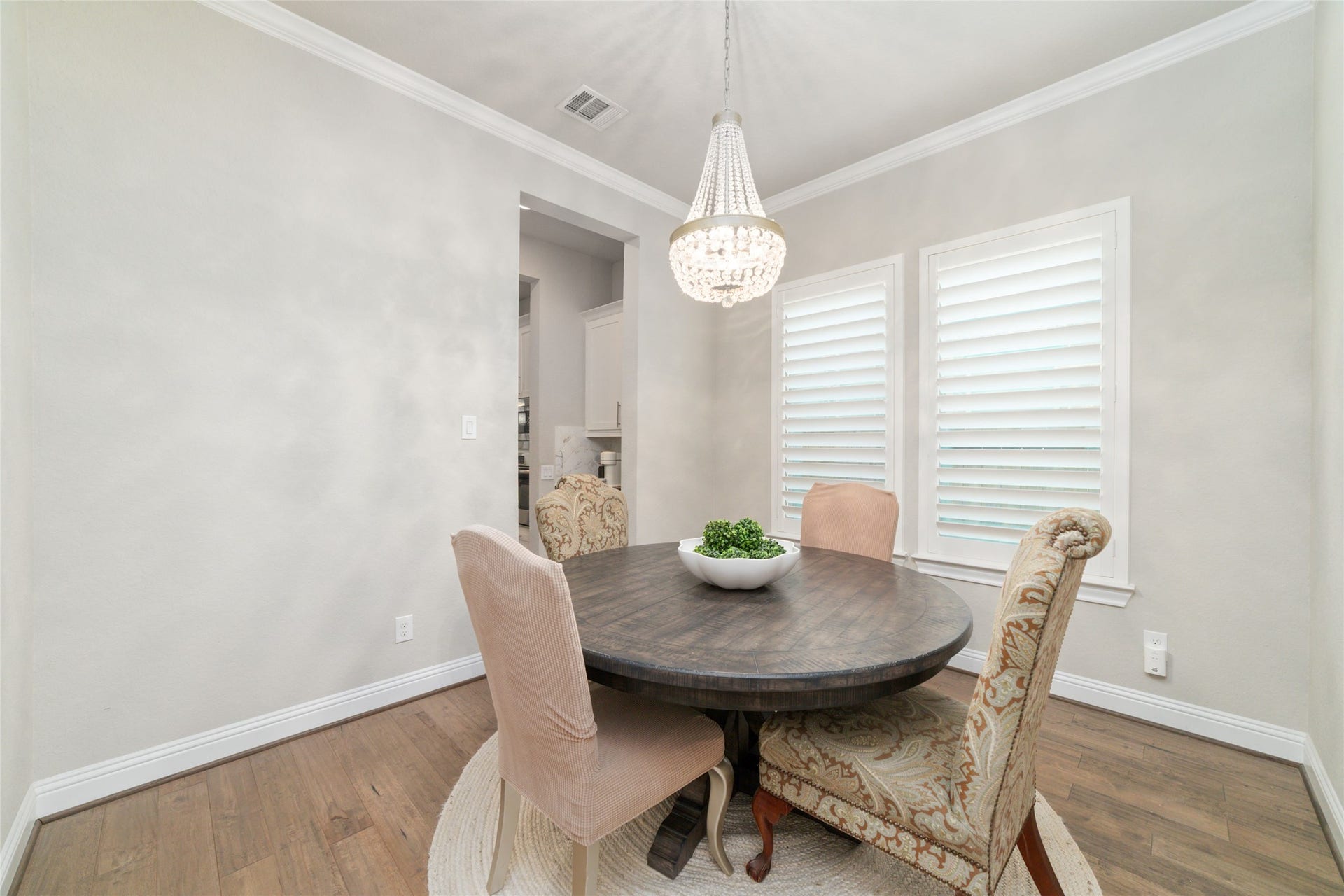 13411 Alpine Mountain Lane, Tomball, TX 77377 A beautiful dining room, enhanced by timeless plantation shutters and a stunning statement chandelier, provides the perfect setting for everyday family dinners and unforgettable holiday gatherings.