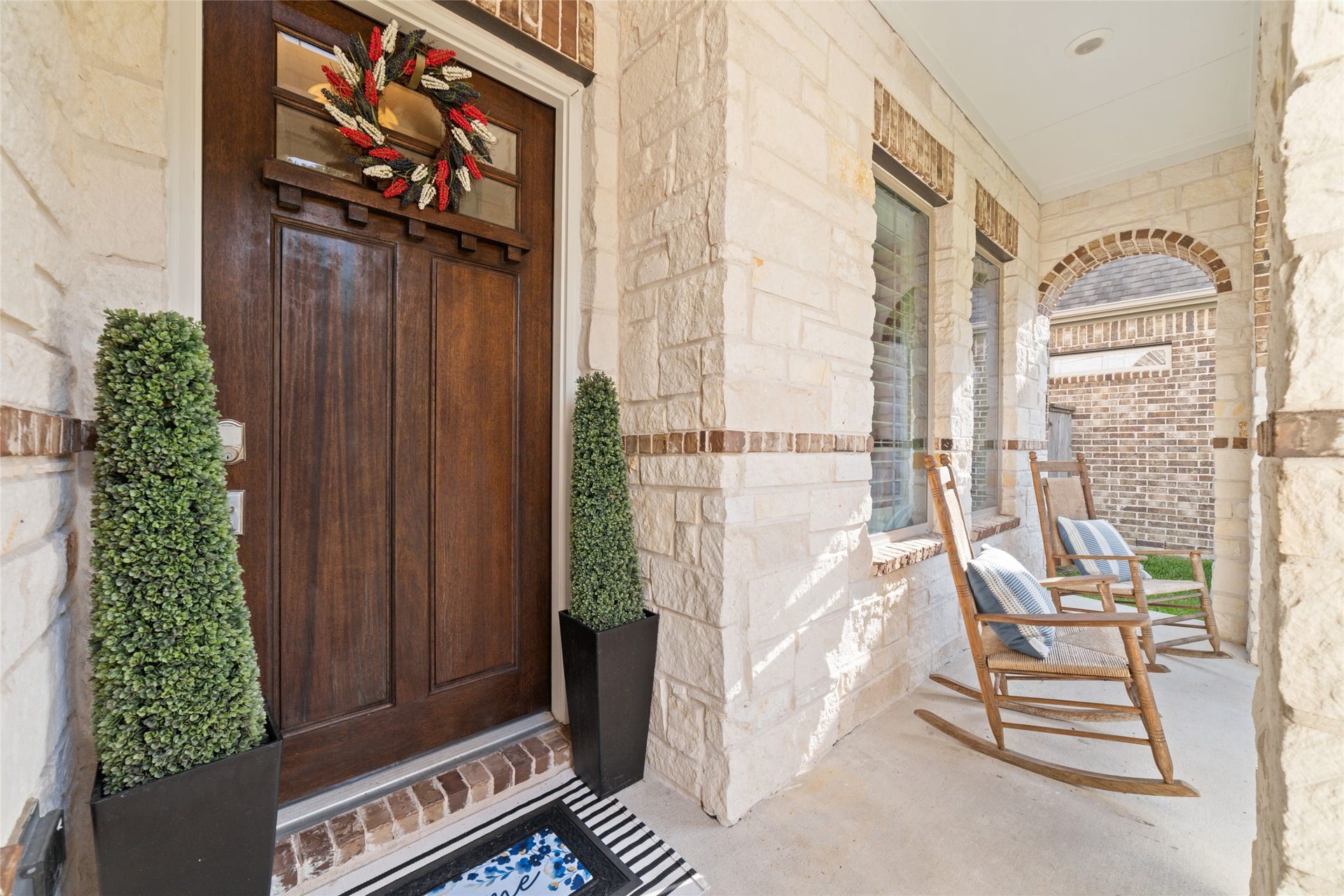 13411 Alpine Mountain Lane, Tomball, TX 77377 The inviting covered front porch, accented by an elegant stone faade, offers a relaxing outdoor retreat with inviting curb appeal.