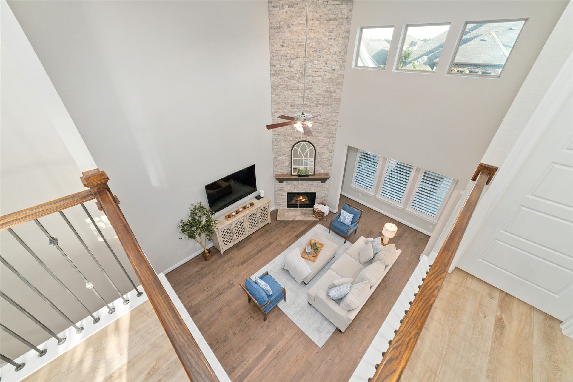 13411 Alpine Mountain Lane, Tomball, TX 77377 View from upstairs balcony showcasing the two story ceilings and stone fireplace.