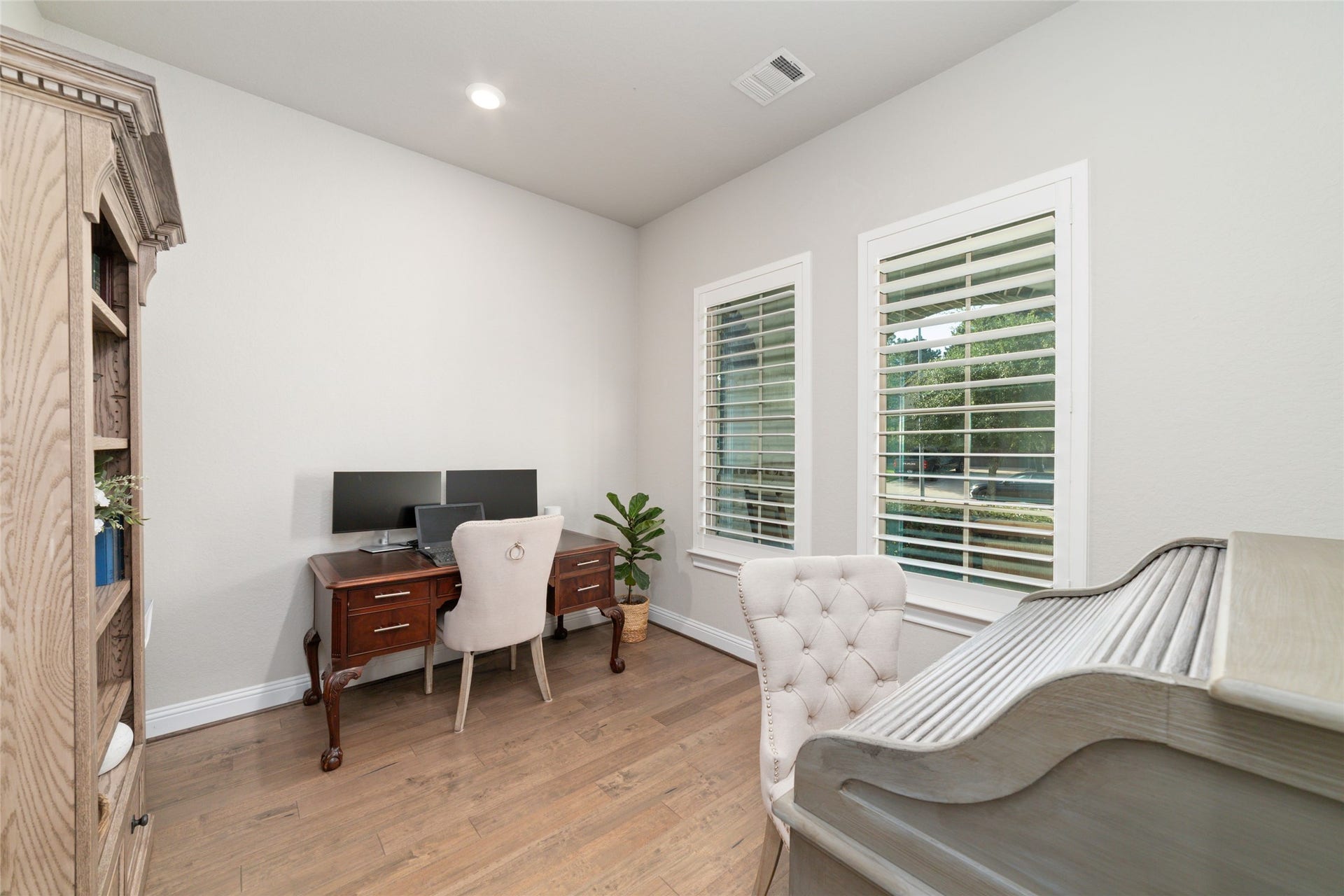 13411 Alpine Mountain Lane, Tomball, TX 77377 The private home office is adorned with elegant & timeless plantation shutters and offers peaceful views of the front yard, creating an ideal work from home space.