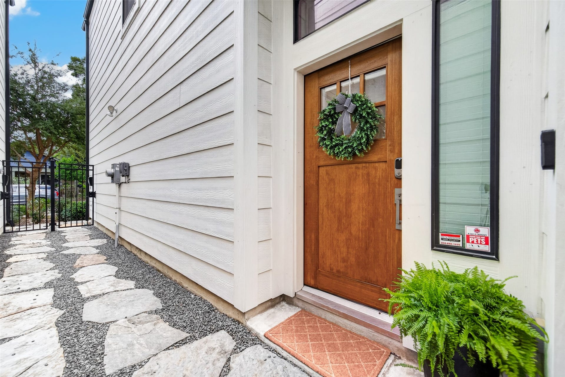 1201 E 23rd Street, Houston, TX 77009 A beautiful wood Craftsman-style door greets you.