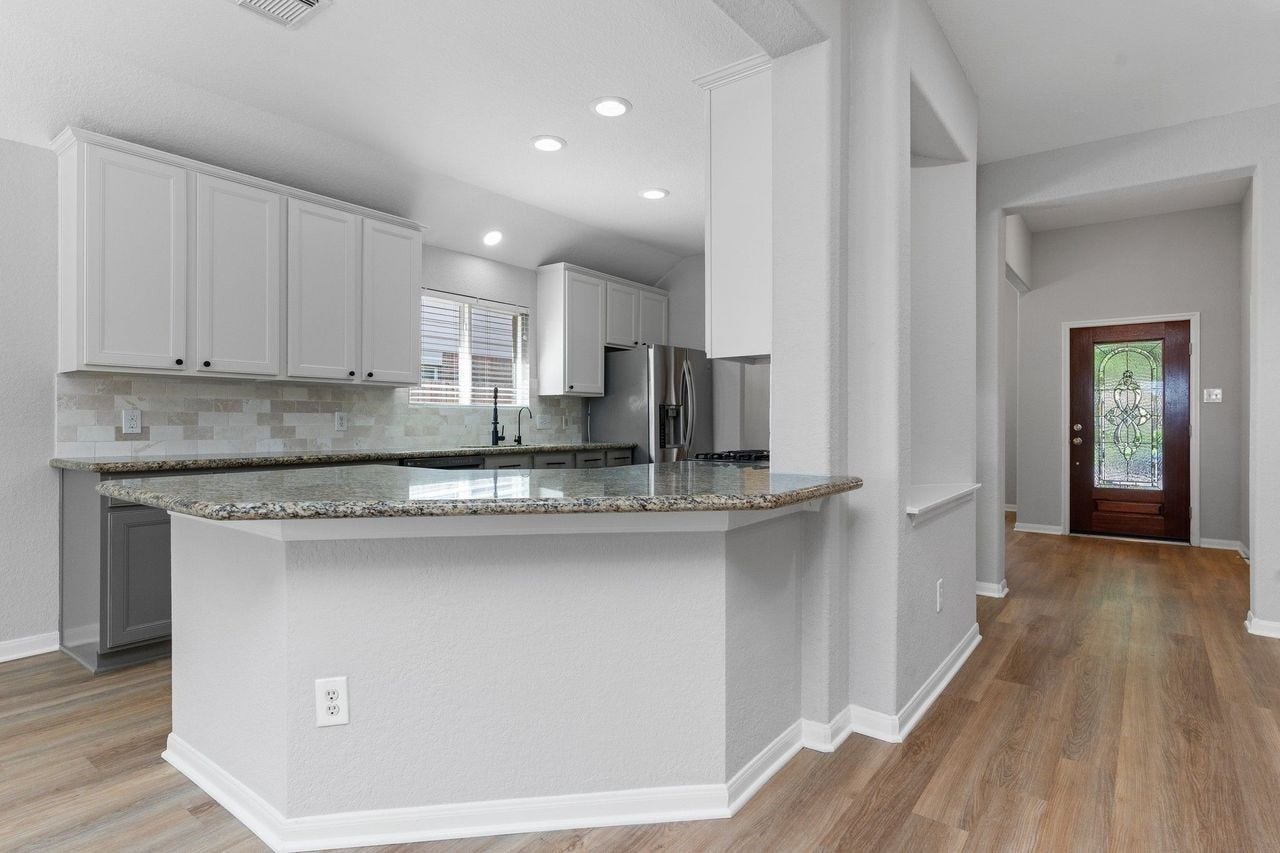 7207 Palmito Ranch Drive, Richmond, TX 77406 The gourmet kitchen showcases stunning granite countertops with upgraded bullnose edges, adding a custom touch of elegance. It's the perfect blend of style, durability, and functionality for everyday living and entertaining.
