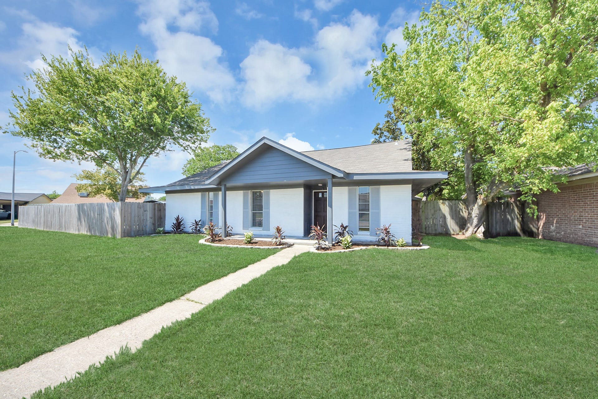 Right side of front showing front lawn and trees