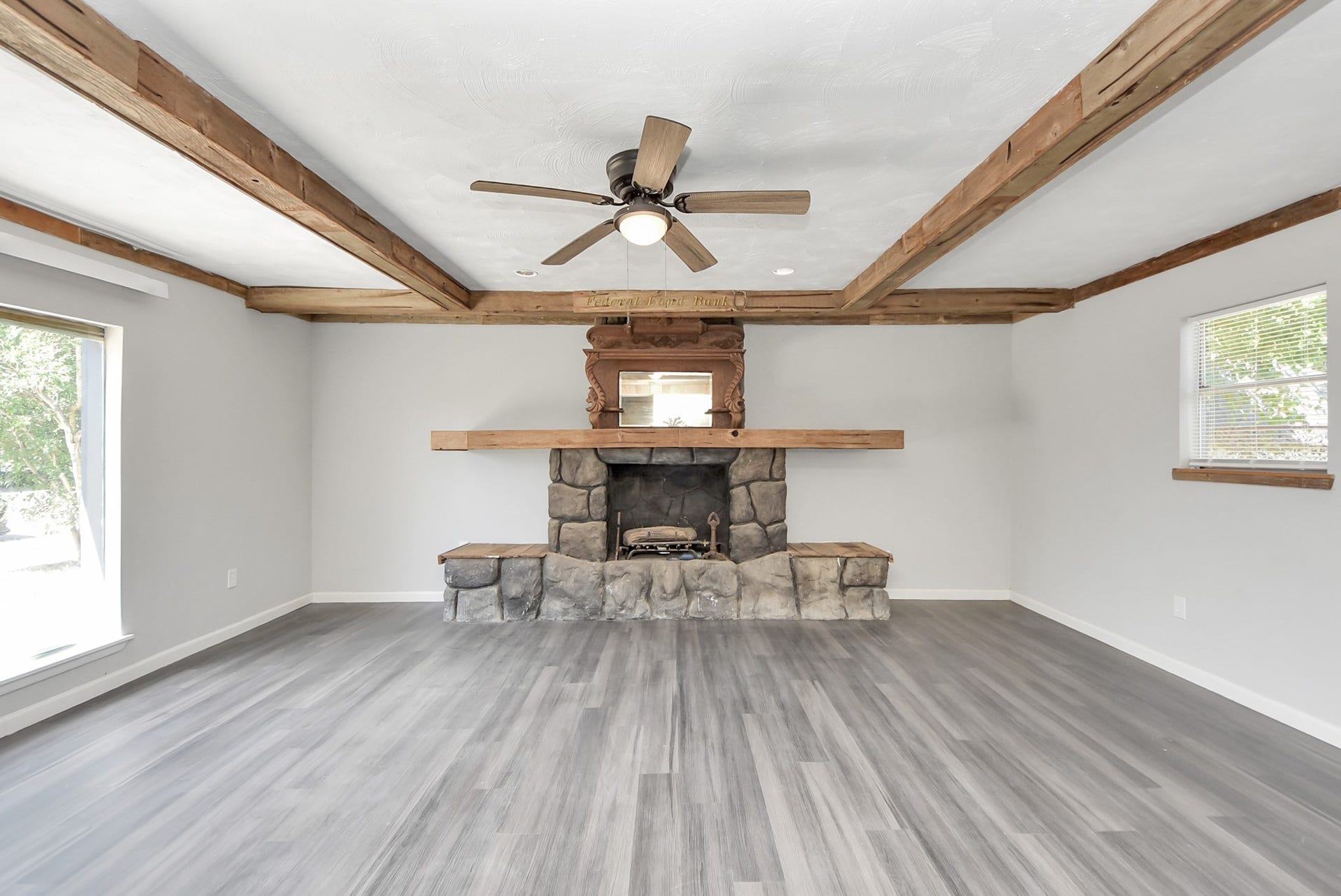 Spacious Den with fireplace and beamed ceiling