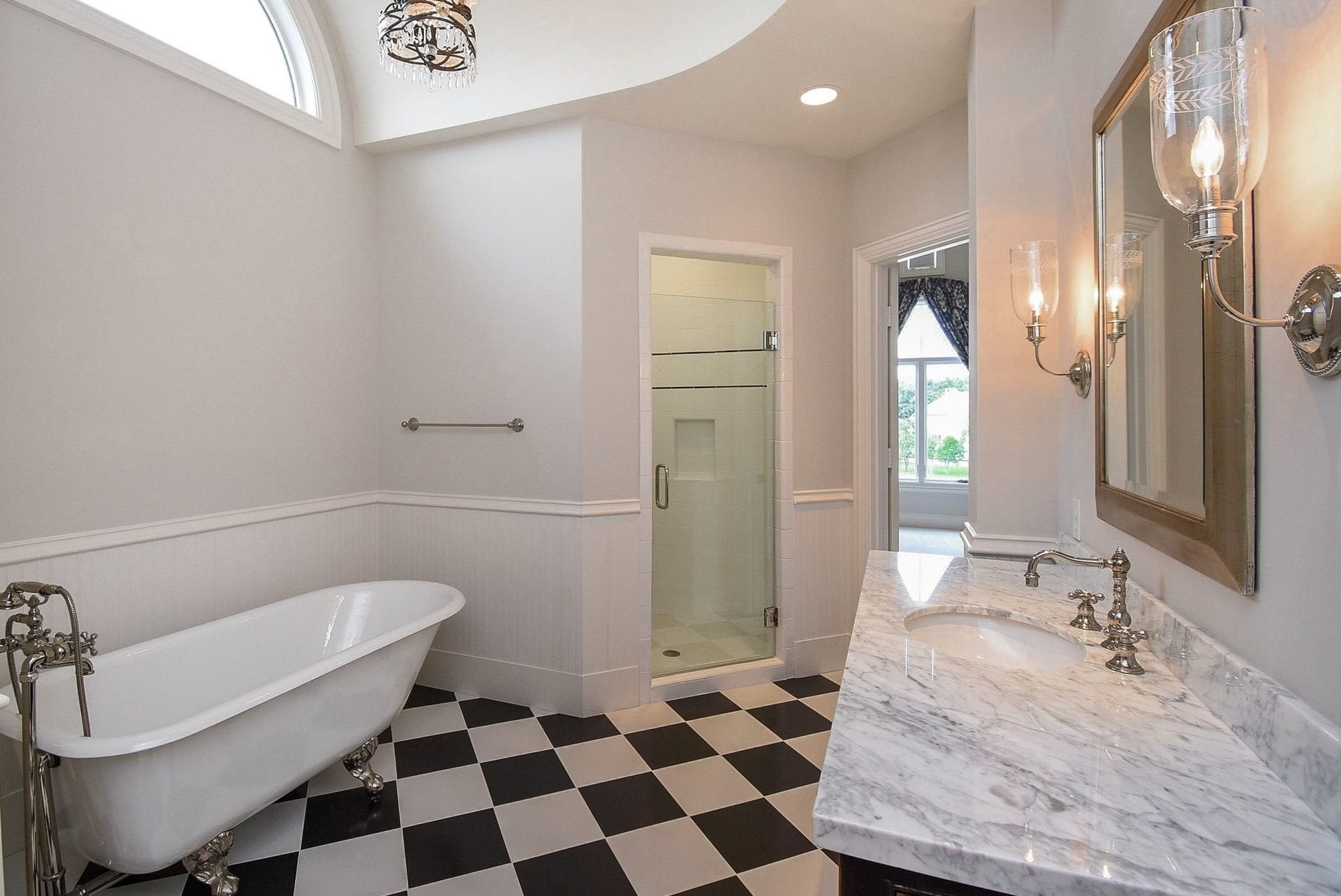 Bathroom 3 has separate shower and great natural light through the transom window above the tub