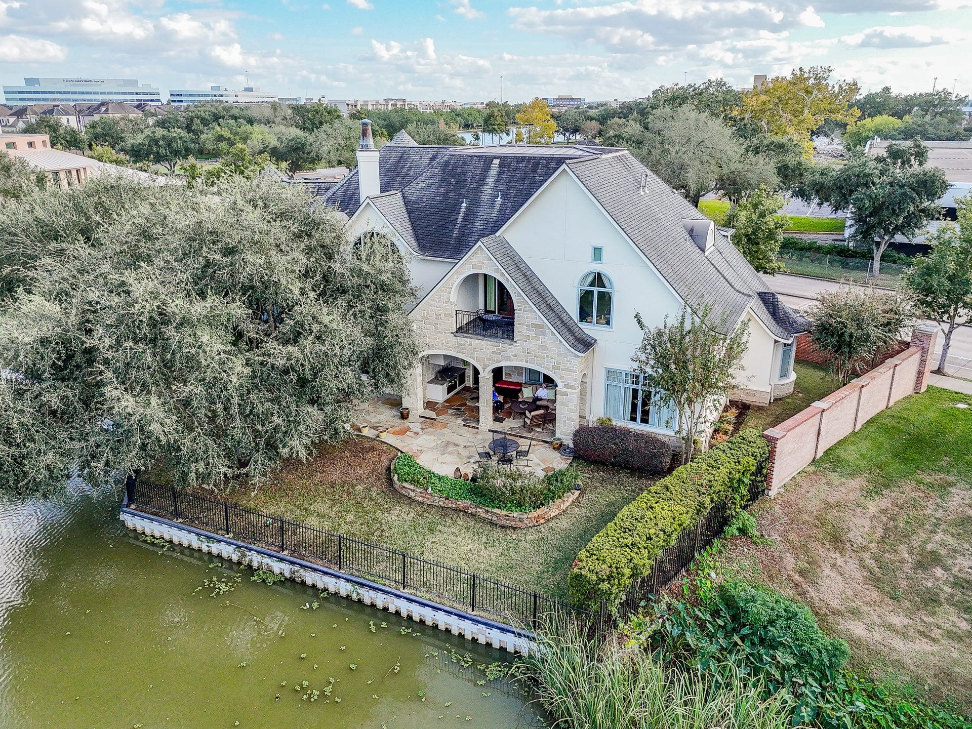 The rear of home with mature landscaping and large covered patio you can see in this photo.   
Enjoy Canoes and Kayaks go by that launch from the nearby Oyster Creek Boathouse