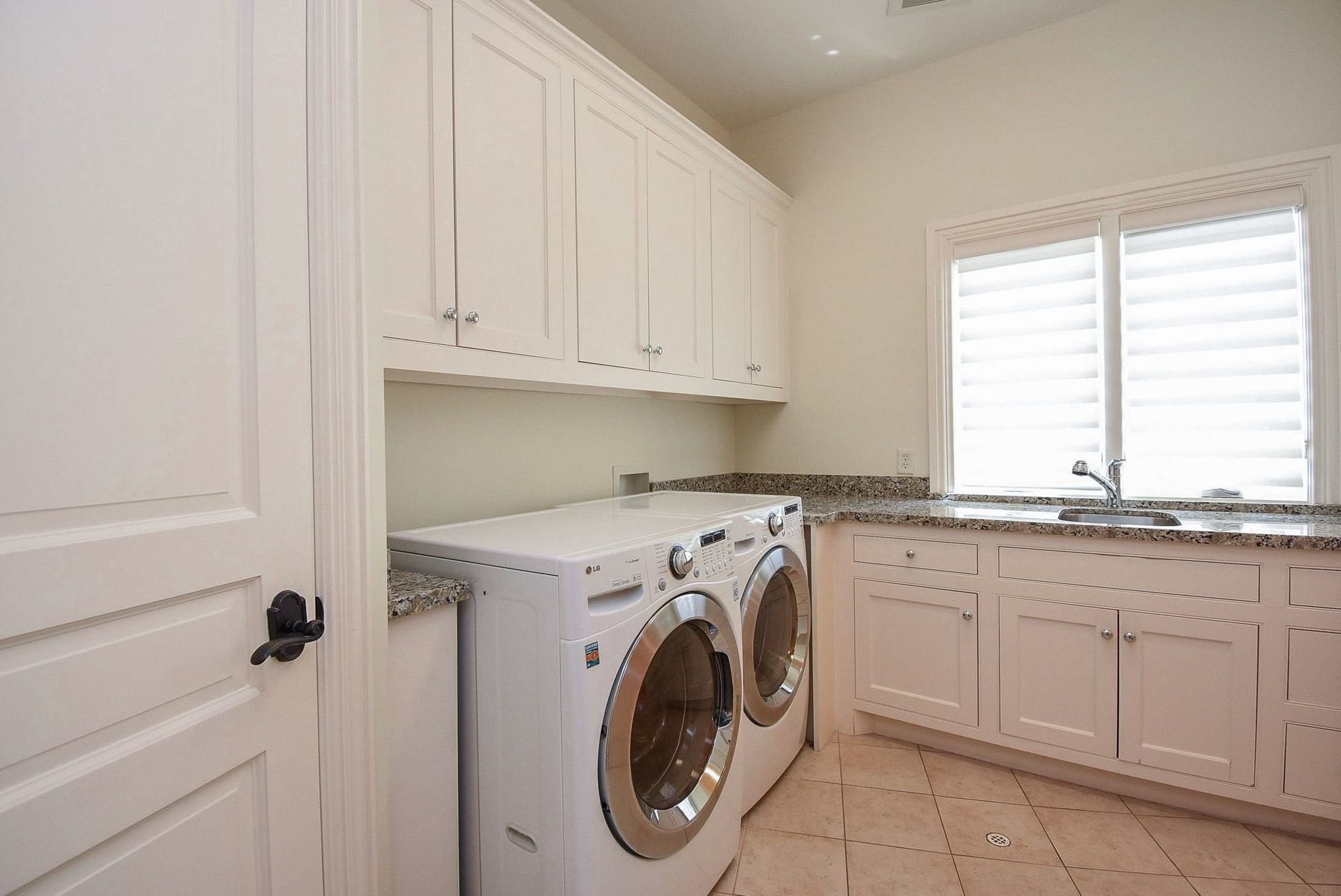 Large laundry room complete with closet, sink and upper and lower cabinets is adjacent to the Primary closet for easy transfer
