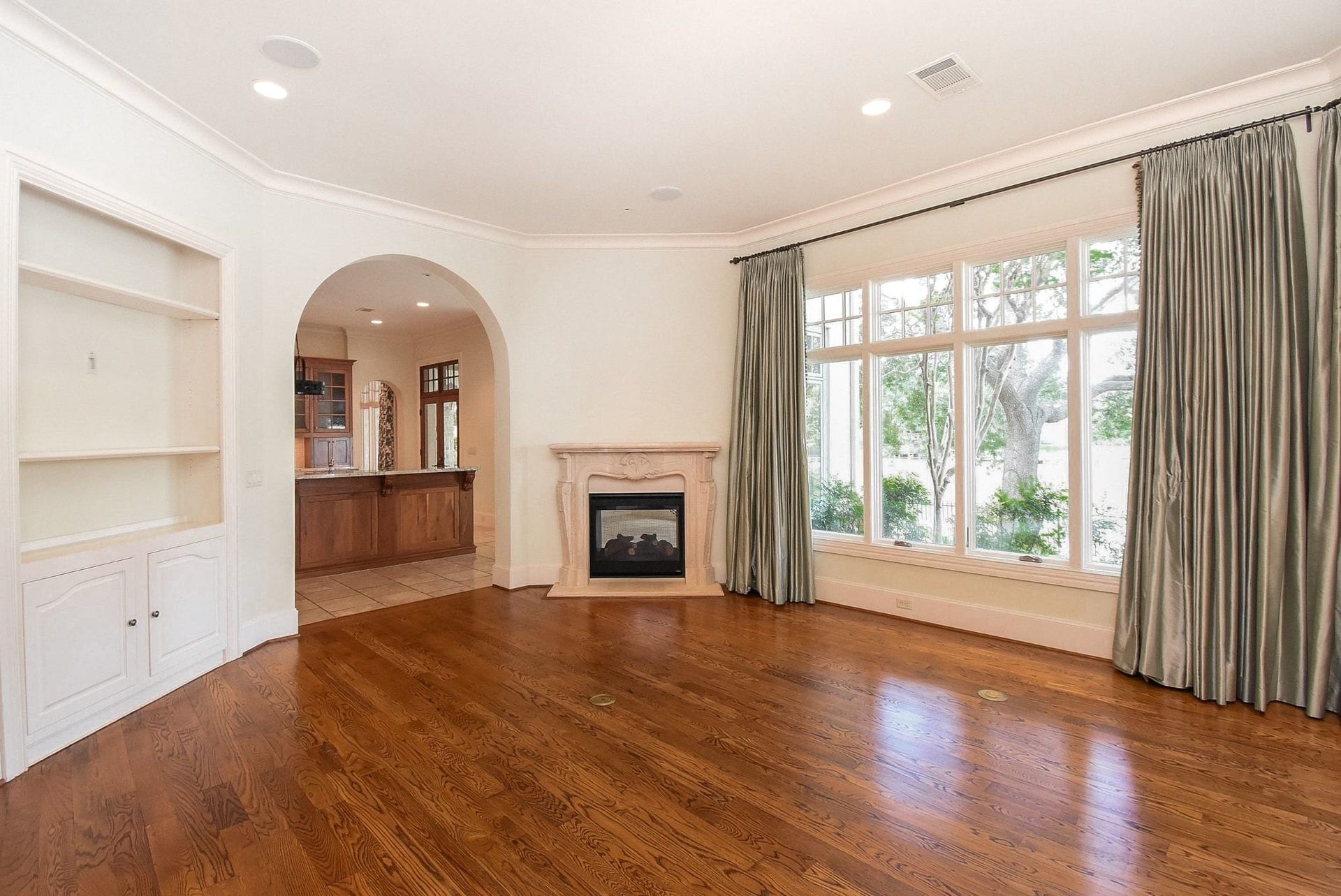 Custom fireplace and gorgeous wood flooring throughout the living areas