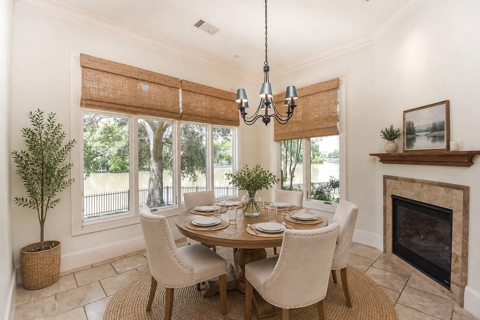 Breakfast areas overlooking the water with dual sided fireplace. Virtually staged