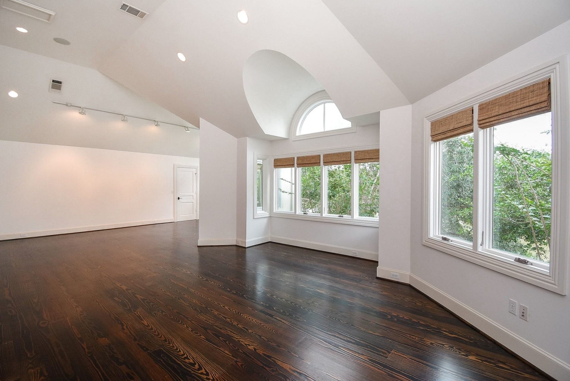 Large bonus room works as a studio, media room or 2nd home office with custom blinds and architecturally creative arches and windows give this room endless possibilities