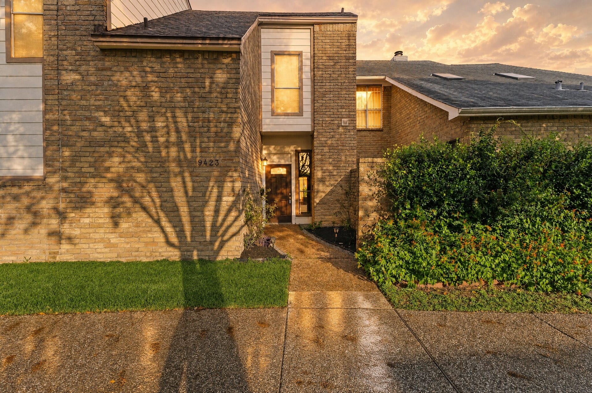 Welcome to 9423 Denbury. This newly renovated brick townhome offers great curb appeal, shaded by mature trees, with a landscaped entry, a pebble walkway lined with path lights, and lush greenery that adds privacy and color.