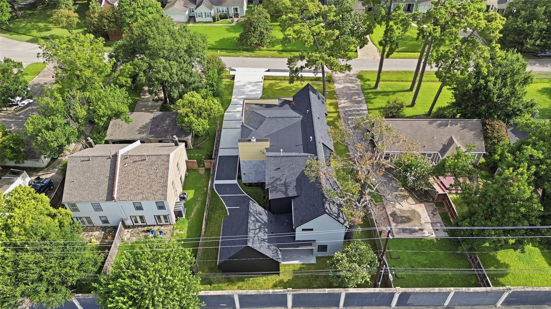 519 W 30th Street, Houston, TX 77018 An aerial view highlights the homes distinctive modern footprint, extended driveway, detached garage, and established Garden Oaks setting. Schedule your private tour and experience 519 W 30th Street in person!