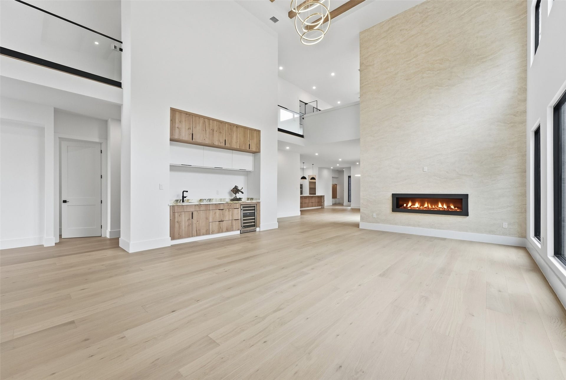 519 W 30th Street, Houston, TX 77018 A sleek built-in bar with warm wood cabinetry and subtle lighting adds both function and sophistication to the open living space.