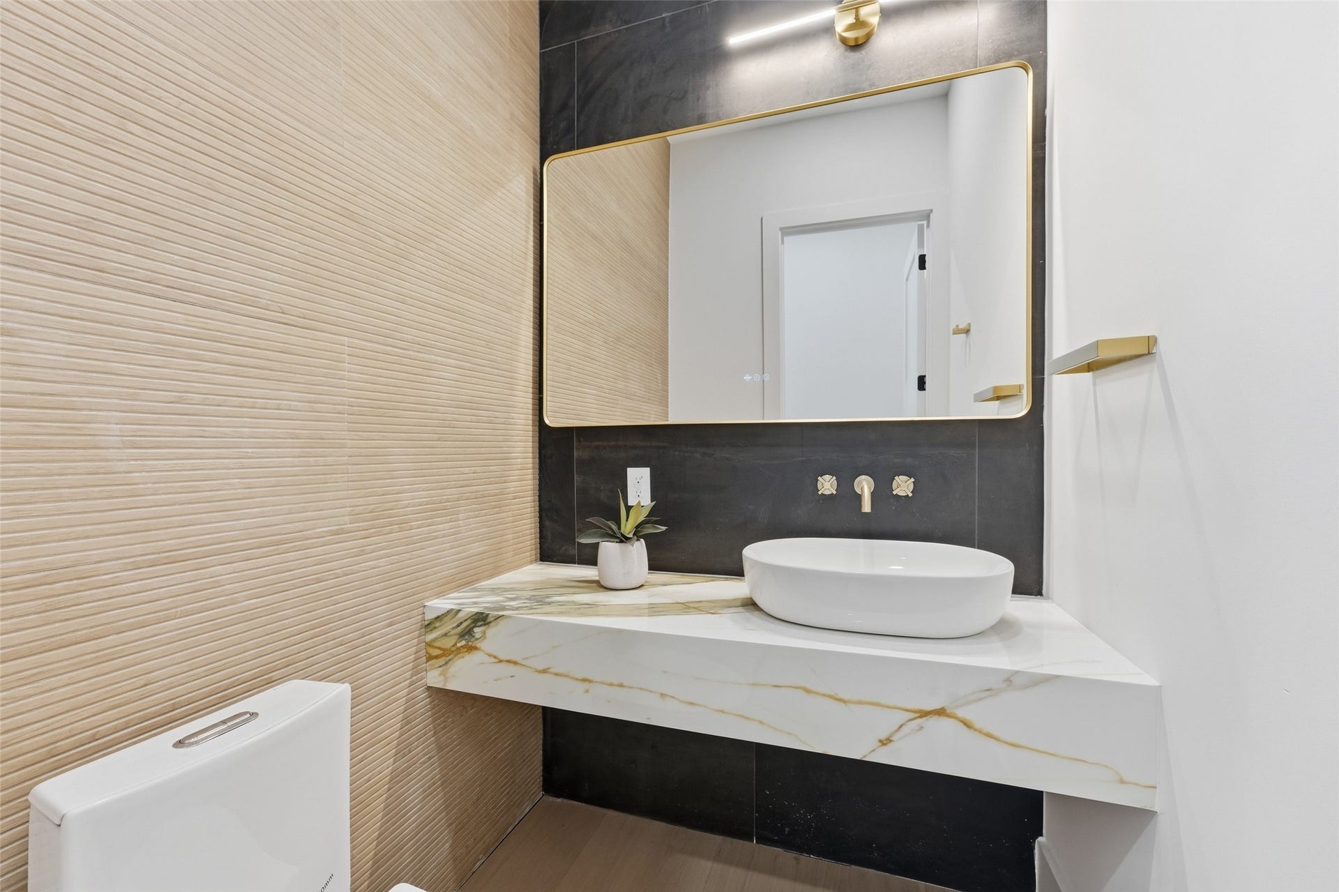 519 W 30th Street, Houston, TX 77018 Discover a serene powder room featuring a sleek floating vanity, striking mirror, and elegant finishes.