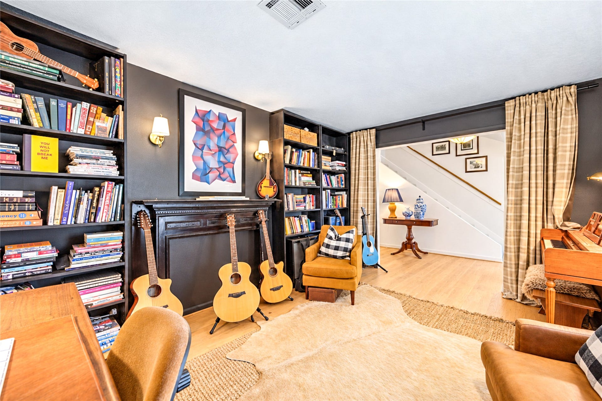 11423 Inwood Drive, Houston, TX 77077 More than just a home office, this charming study is a space to slow down and stay inspired! Floor-to-ceiling bookshelves, warm wood floors and thoughtfully layered designer details create a cozy, sophisticated atmosphere. With plenty of room to work, read or unwind, this versatile retreat is perfect for quiet mornings, creative afternoons or escaping into a favorite book.