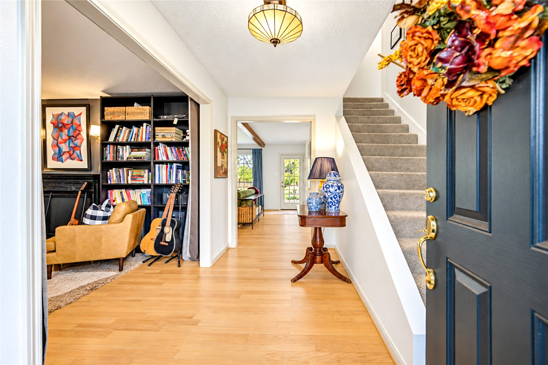11423 Inwood Drive, Houston, TX 77077 First impressions set the tone! Step inside to beautiful wood floors, a welcoming entry and thoughtfully curated designer touches that give this home its unique personality. Just off the foyer, a cozy study with floor-to-ceiling bookshelves offers the perfect escape for morning coffee, a favorite book or a quiet work-from-home retreat. A warm and inviting introduction to the spaces beyond!