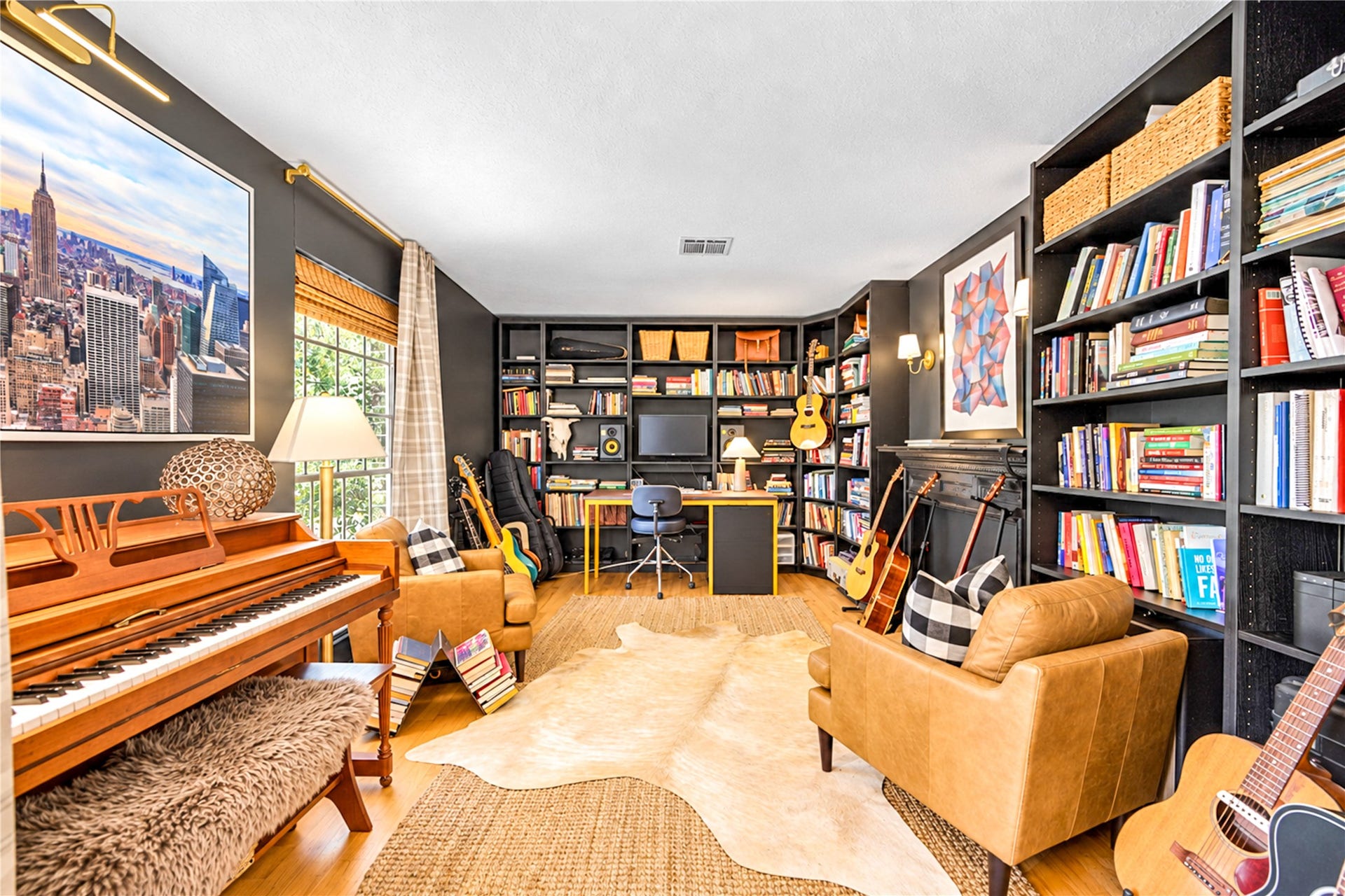 11423 Inwood Drive, Houston, TX 77077 A room to inspire! This inviting study blends timeless charm with designer personality, featuring dramatic floor-to-ceiling bookshelves, warm wood floors and abundant natural light. Whether you're working from home, curling up with a favorite novel or enjoying a quiet afternoon, this thoughtfully styled retreat offers the perfect place to relax, recharge and feel right at home.