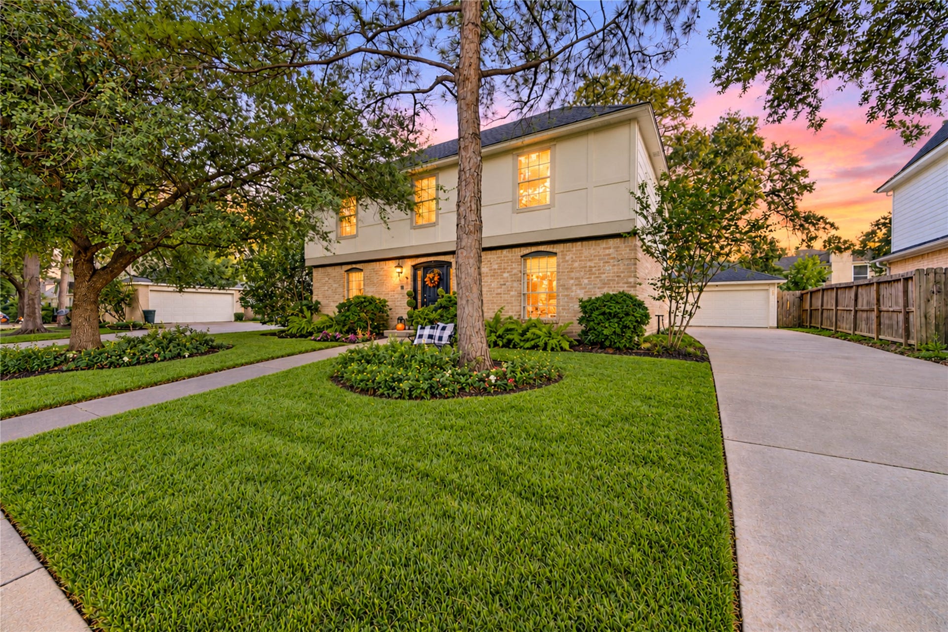 11423 Inwood Drive, Houston, TX 77077 Come home to timeless charm and a welcoming neighborhood atmosphere! This beautiful two-story home features a sweeping driveway, lush manicured lawn and mature trees that frame its classic brick exterior. As evening falls, the warm glow from the windows creates an inviting scene, while the spacious front yard adds to the home's picturesque curb appeal. A lovely place to begin and end each day in the heart of Village West!