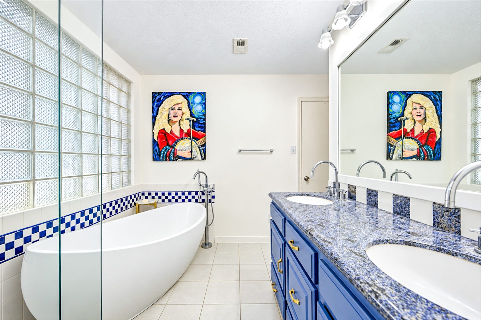 11423 Inwood Drive, Houston, TX 77077 Your own spa-inspired escape! The beautifully renovated second-floor primary ensuite bath offers a refreshing blend of modern elegance and designer style. Unwind in the freestanding soaking tub, enjoy the separate walk-in shower and appreciate the striking blue vanity, sleek countertops and stylish tile accents. A bright, serene retreat designed to make everyday routines feel like a luxurious getaway!