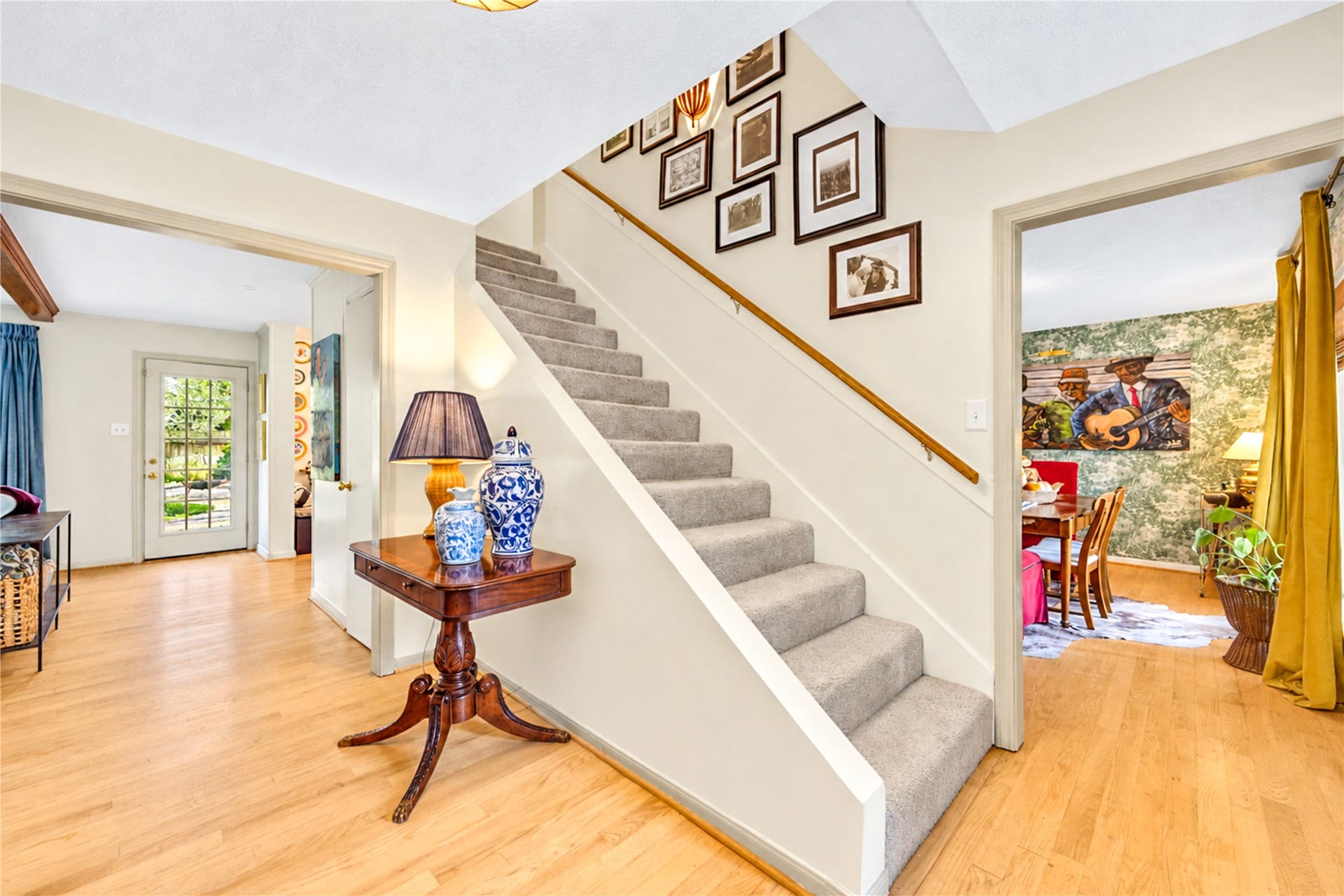 11423 Inwood Drive, Houston, TX 77077 A welcoming entry with effortless flow! Beautiful wood floors, crisp neutral walls and a staircase accented with a charming gallery wall create a warm, inviting atmosphere. Thoughtful designer details add personality, while the open layout offers a natural connection to the home's comfortable living spaces. Every corner feels like home!