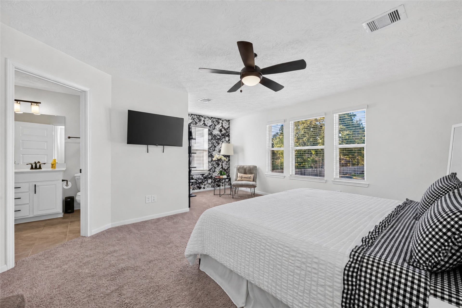 9453 Castillo Court, Magnolia, TX 77354 This spacious primary suite has room for both relaxation and a comfortable sitting area. Imagine starting your morning with a favorite book or winding down in your own peaceful retreat.