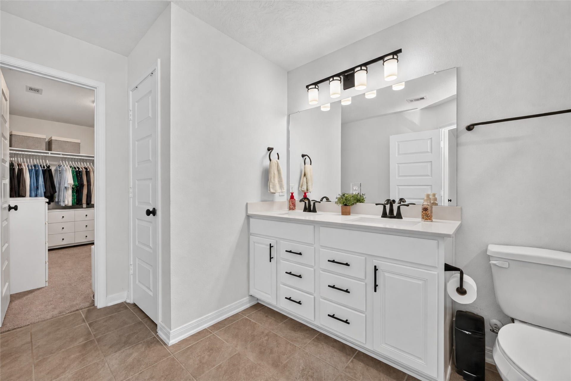 9453 Castillo Court, Magnolia, TX 77354 Start your morning with the convenience of a spacious vanity featuring generous countertop space and storage. The bright finishes create an inviting atmosphere for your daily routine.