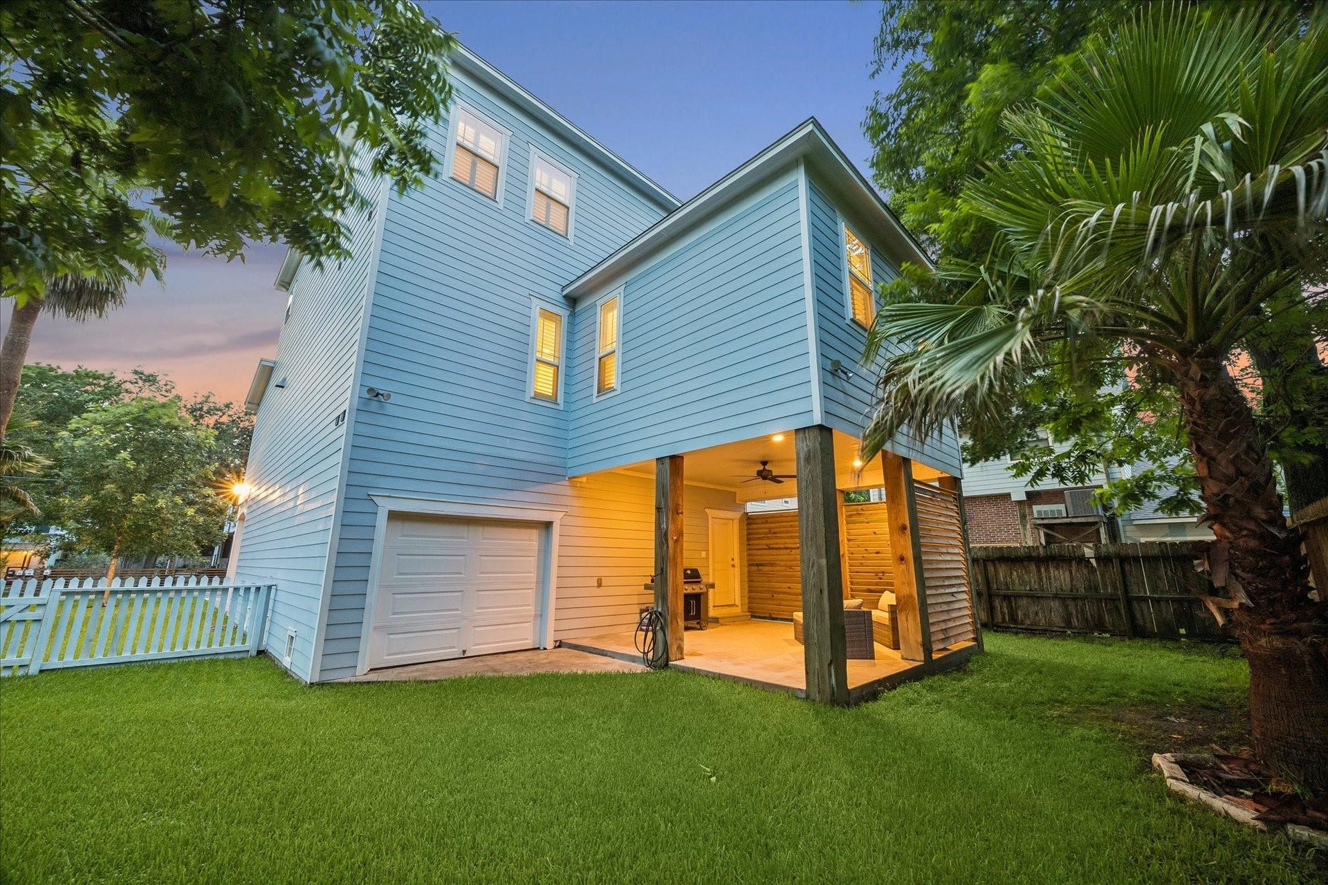 209 Queen Road, Clear Lake Shores, TX 77565 Complete with a white picket fence, garage access and mature trees for added privacy and shade