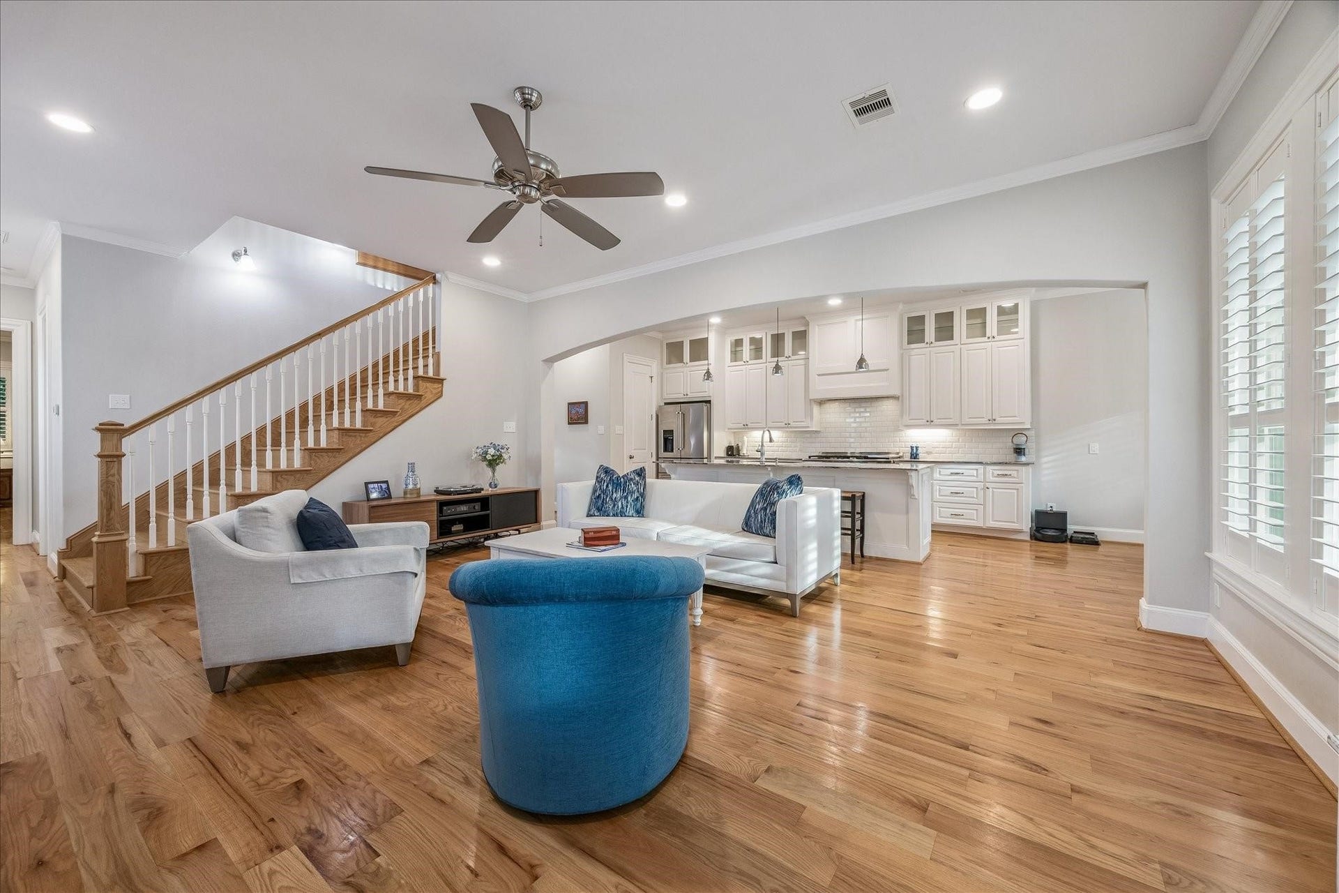 209 Queen Road, Clear Lake Shores, TX 77565 Step inside to this spacious, open-concept living area featuring warm hardwood floors and high ceilings, creating a welcoming atmosphere