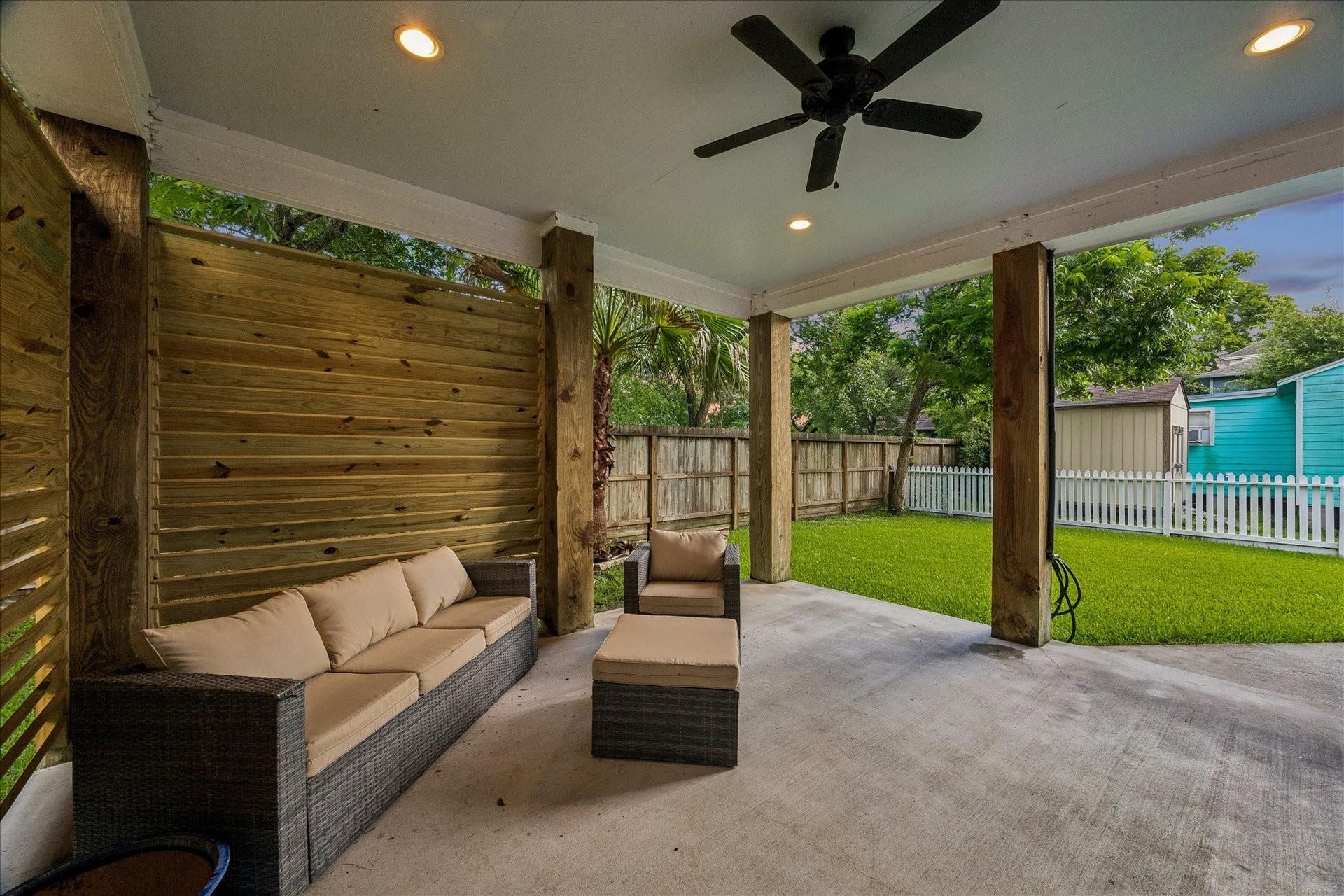 209 Queen Road, Clear Lake Shores, TX 77565 This backyard features a covered patio with ceiling fan, recessed lighting and louvered walls for added privacy